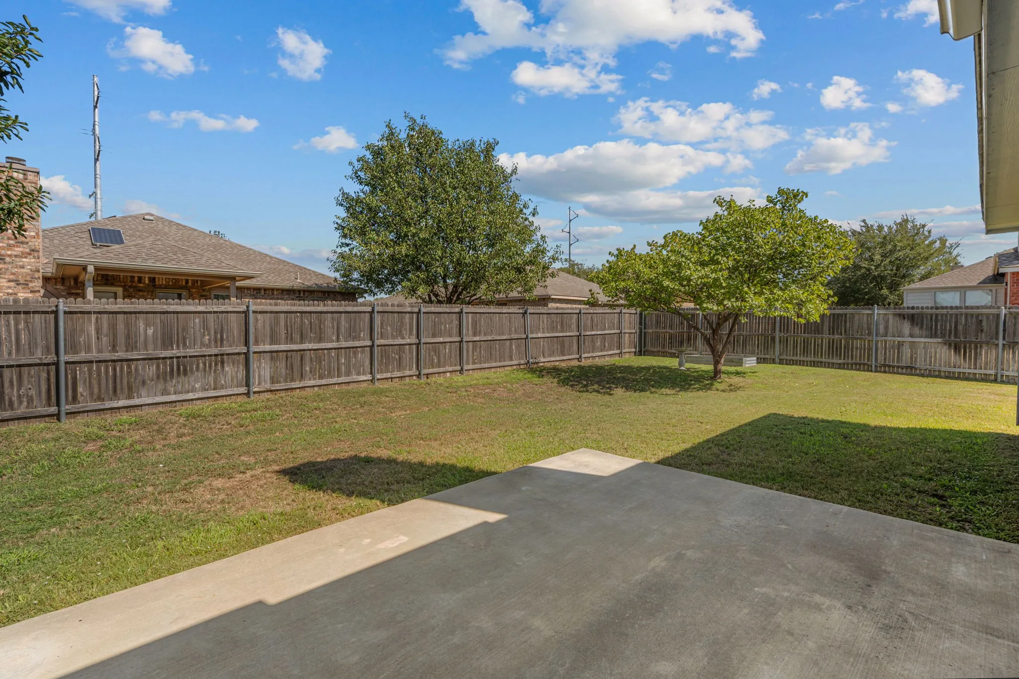Back yard is shaded in the afternoon. Great space for a grill or play set for kids!