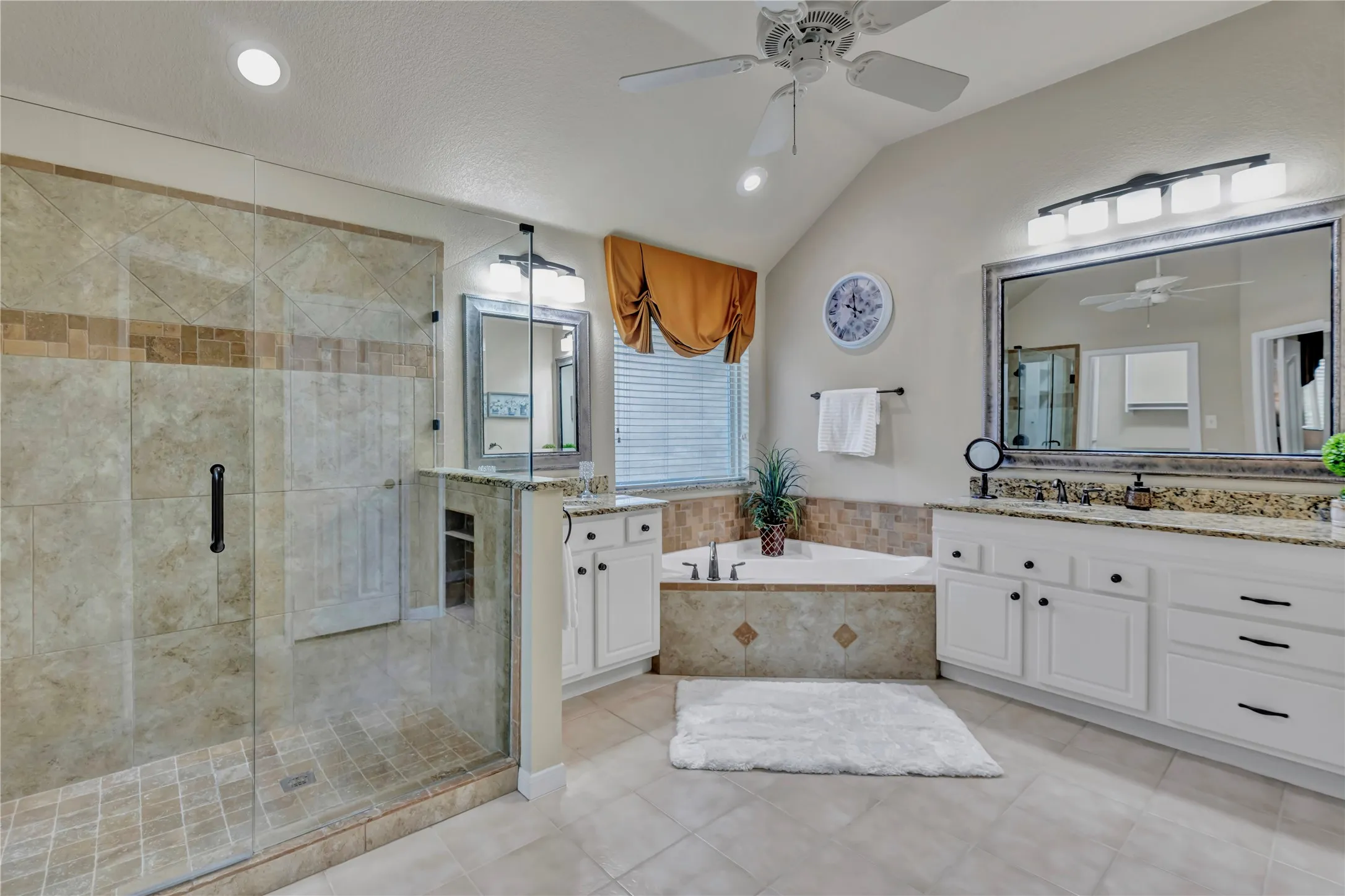 Spacious primary bathroom with wonderful walk-in shower and seperate vanities