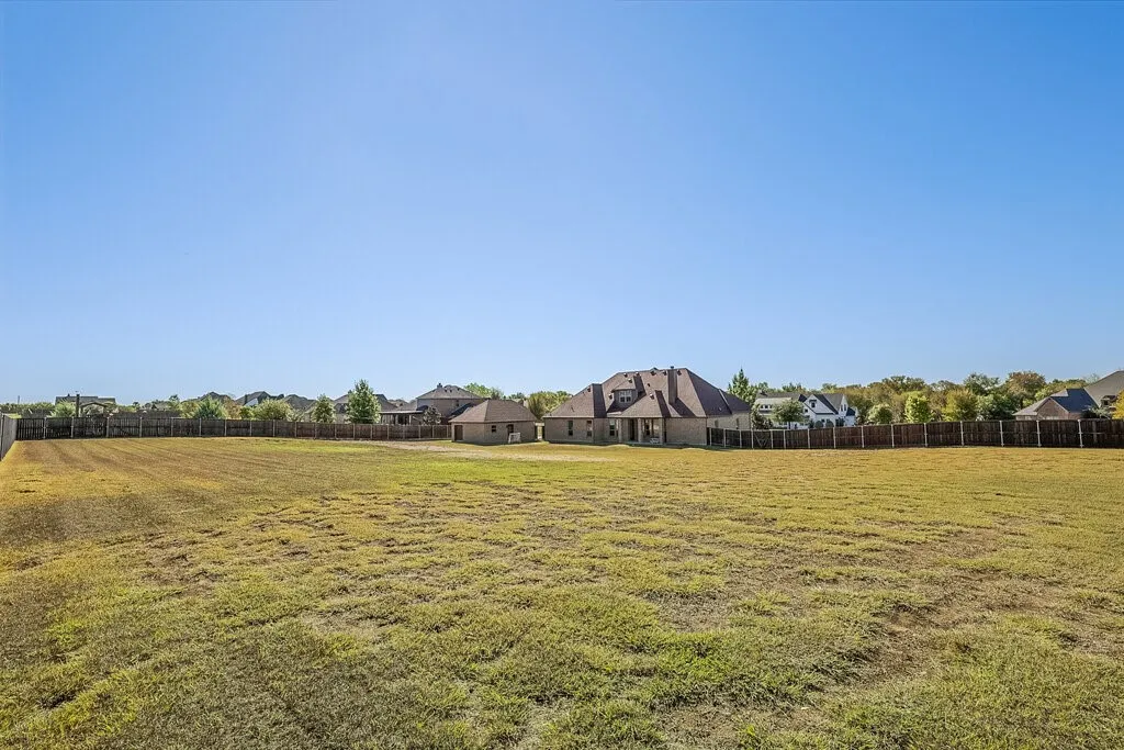 Expansive undeveloped lot with perimeter fencing