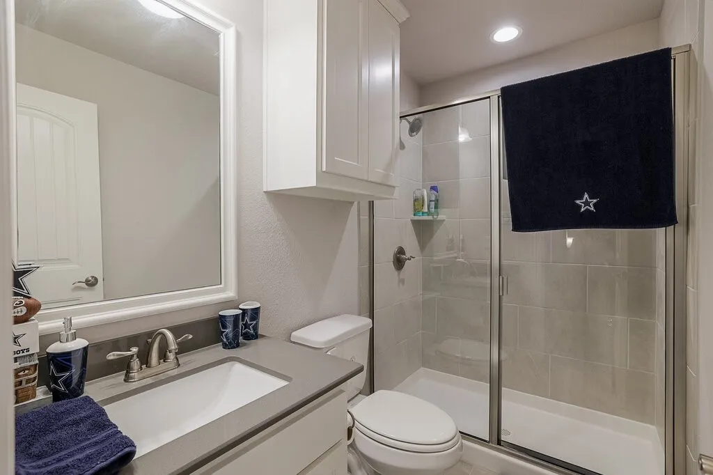 Vanity with an integrated rectangular sink, gray countertop, and brushed nickel faucet