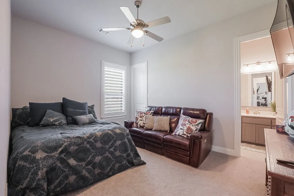 Recessed lighting, ceiling fan, window with white plantation shutters, and light-colored carpeting