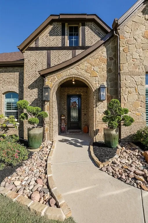 Brick and stone exterior with an arched entryway