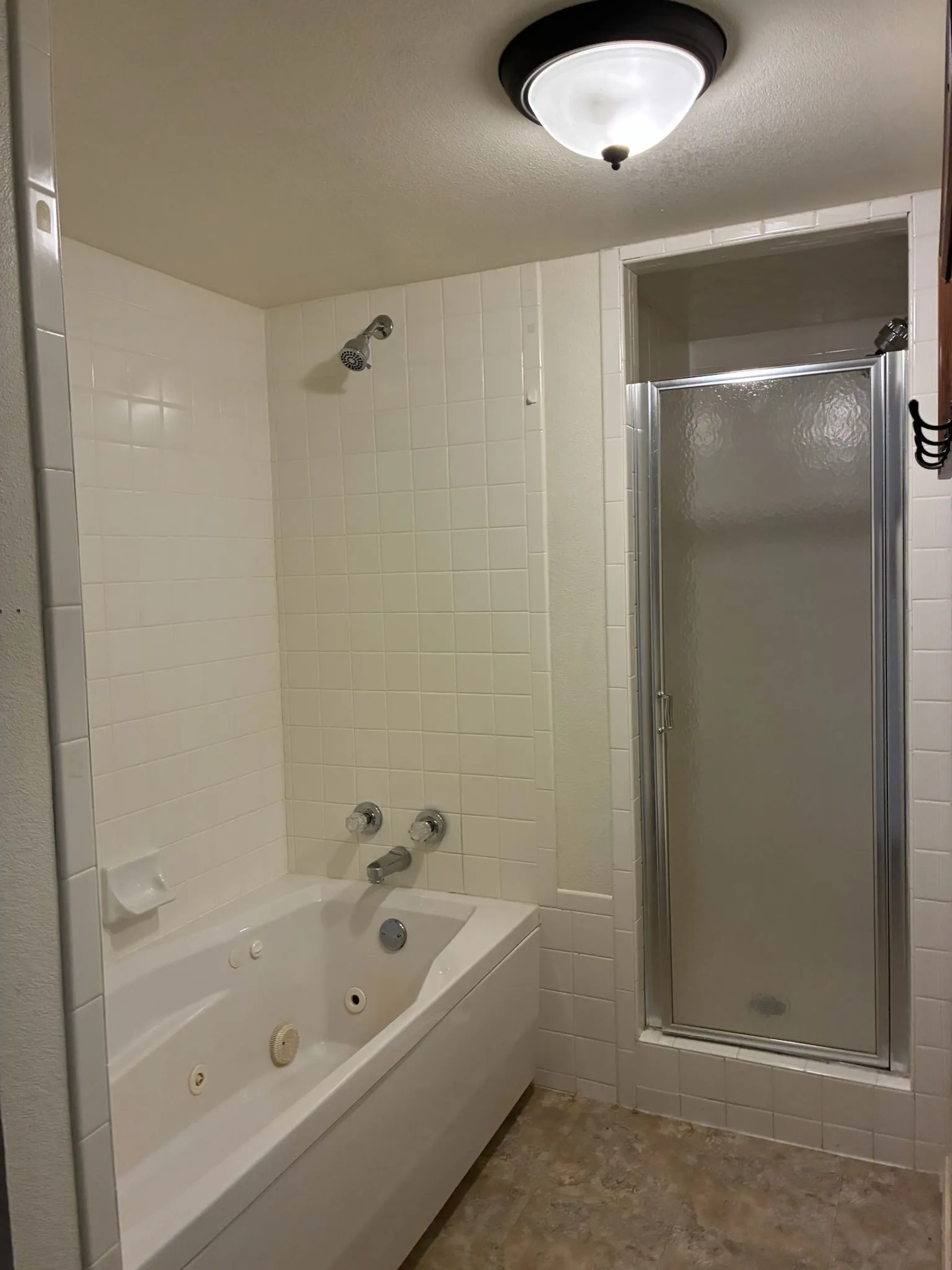 Full bath with a combined bath / shower with jetted tub
