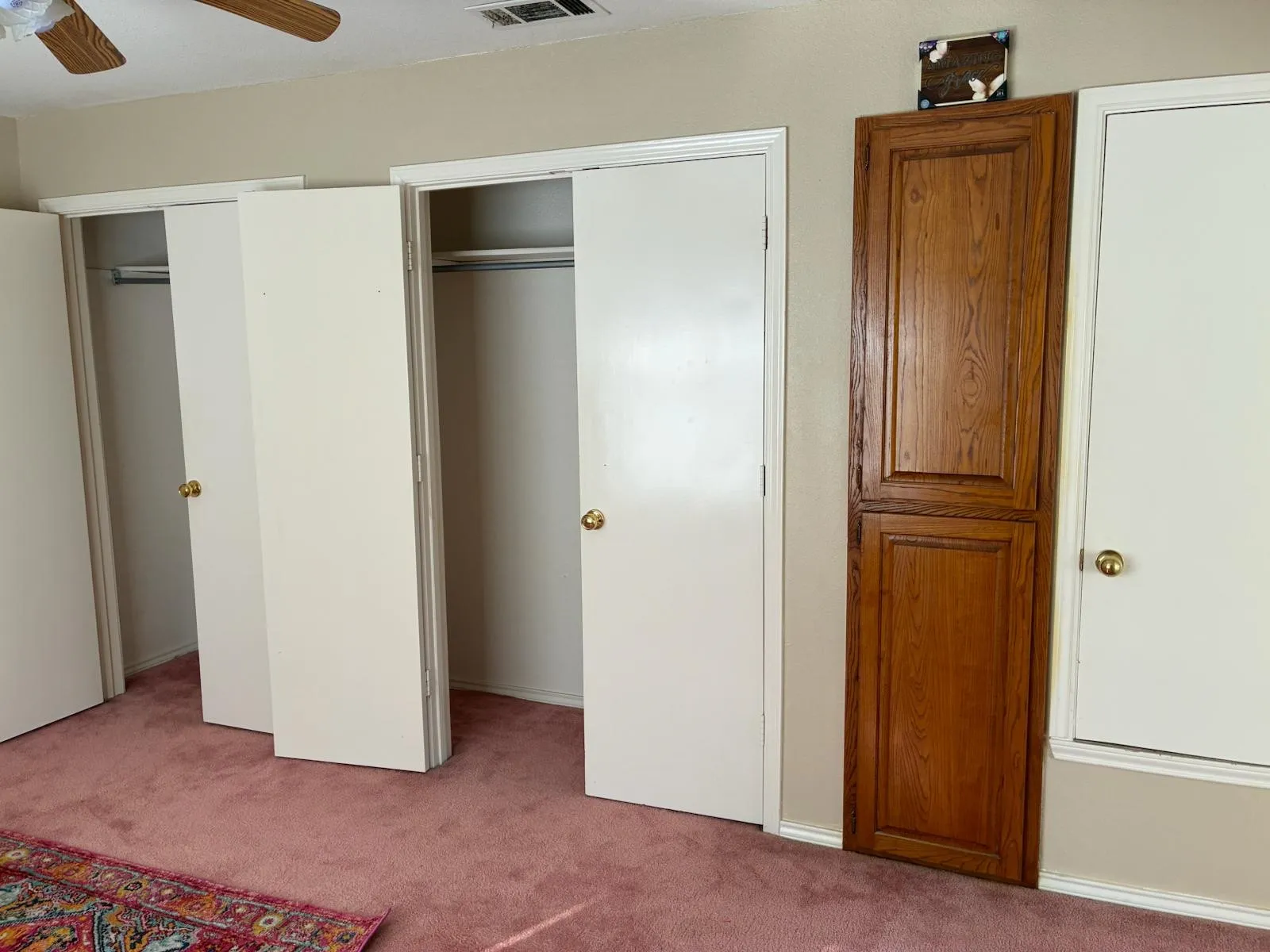 Unfurnished bedroom with multiple closets, carpet floors, and a ceiling fan