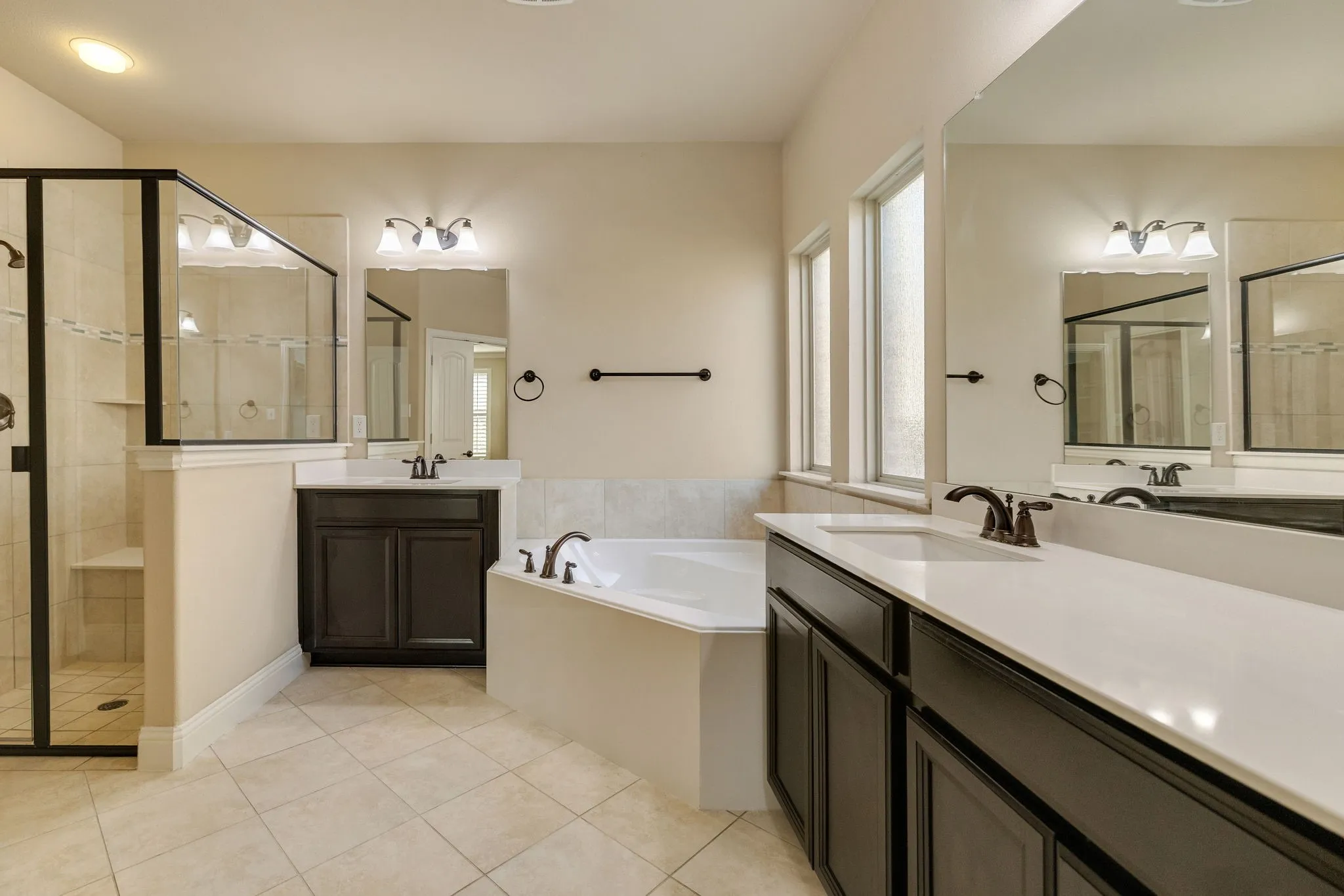 Dual vanities with undermount sinks and dark wood-finish cabinetry