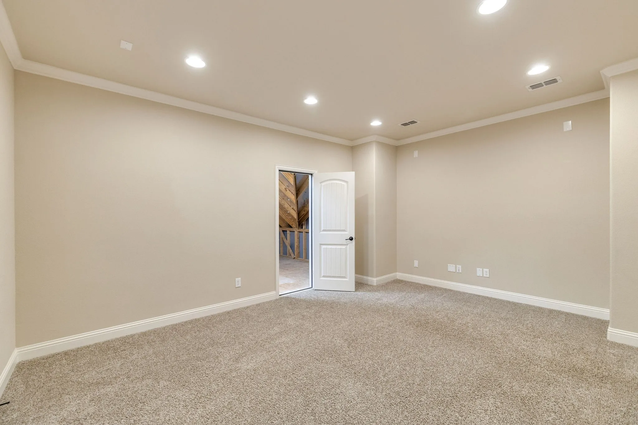 Neutral-toned carpeting with recessed lighting