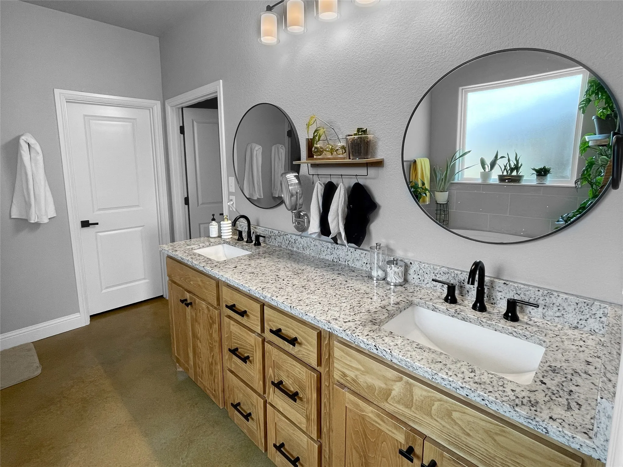 Dual vanity with wood-finish cabinetry and black hardware