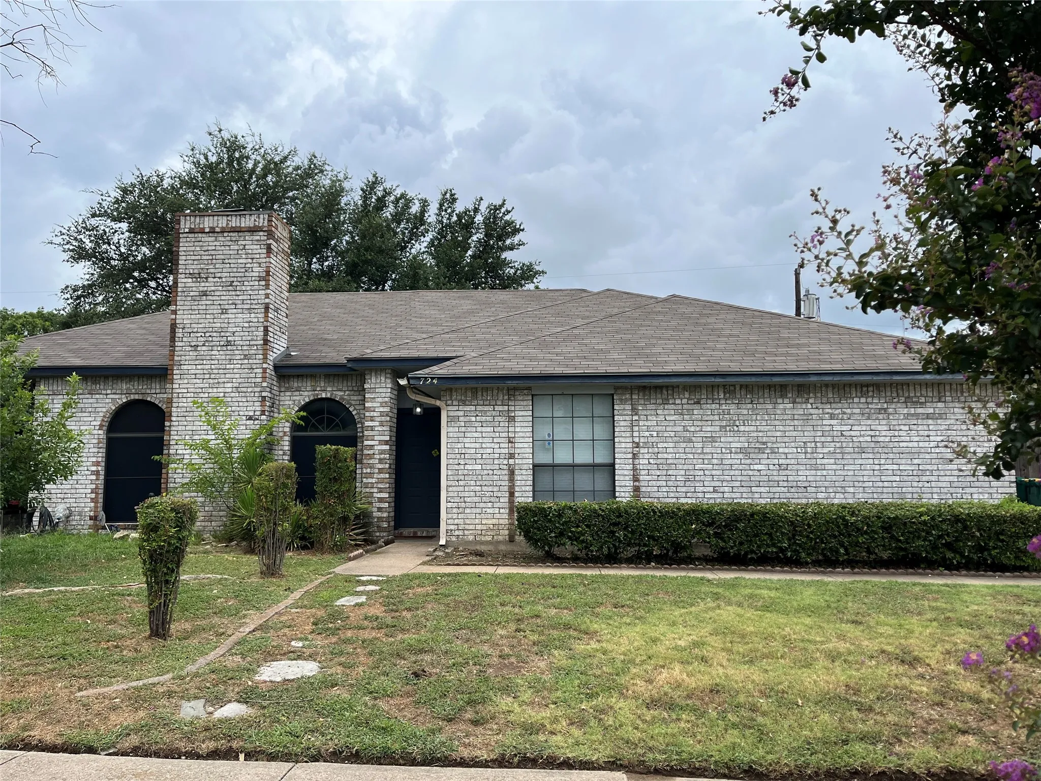 Single story home with a front lawn