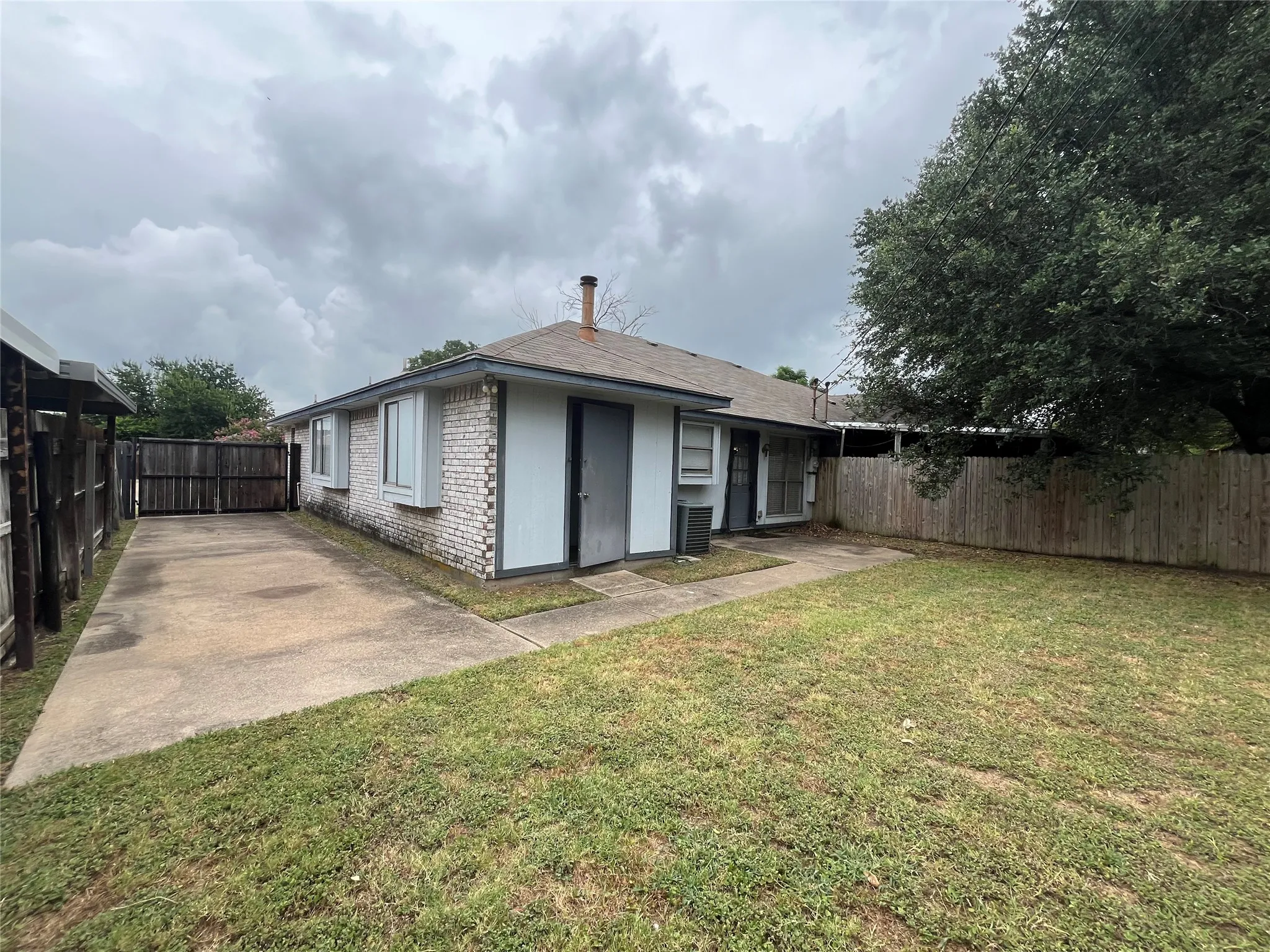 Rear view of house featuring a lawn