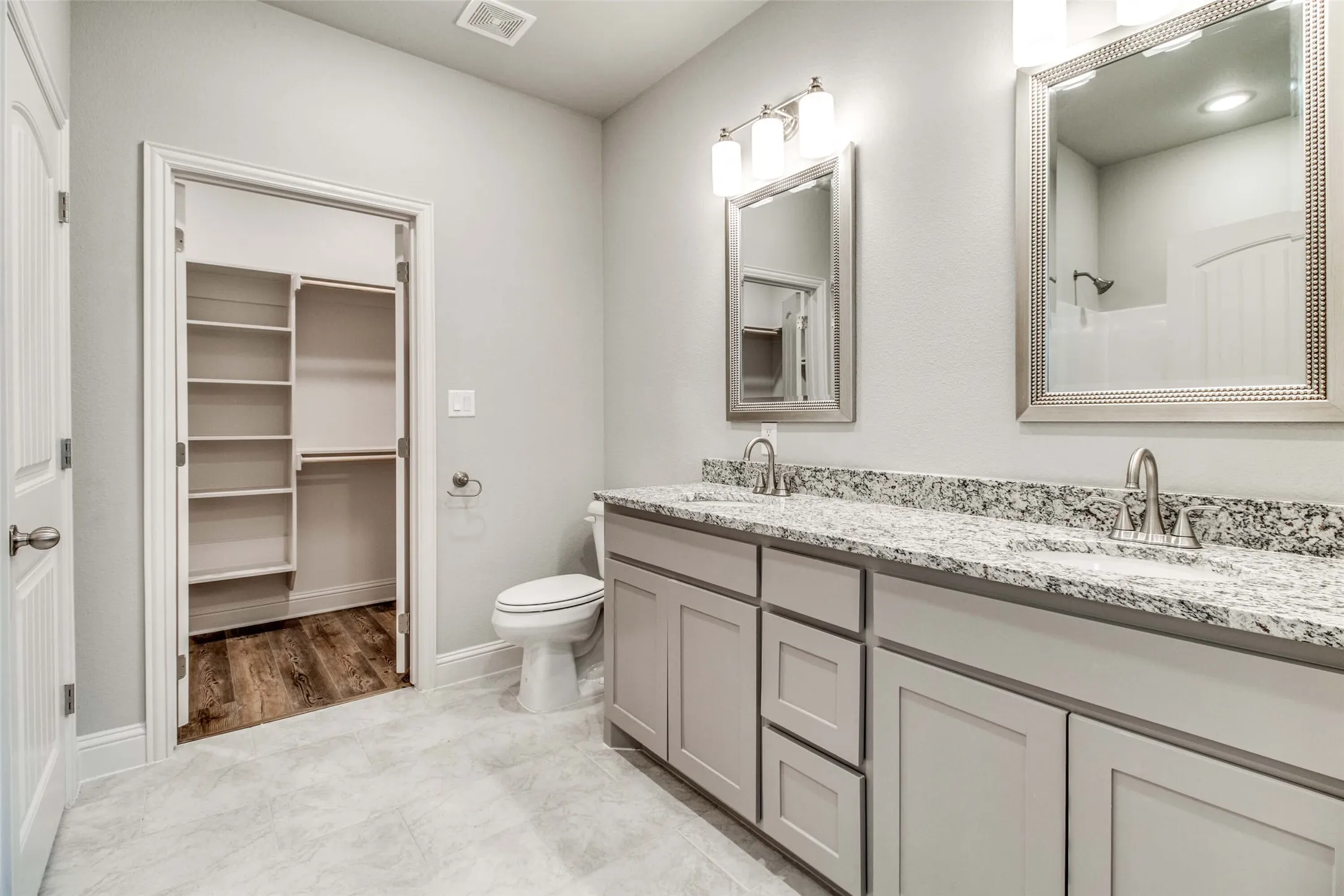 Dual vanity with stone-finish countertop and undermount sinks