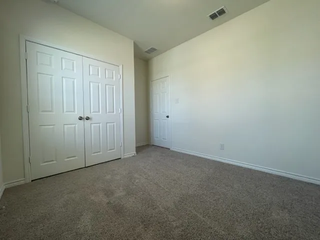 Neutral-toned carpeting complements light wall finishes