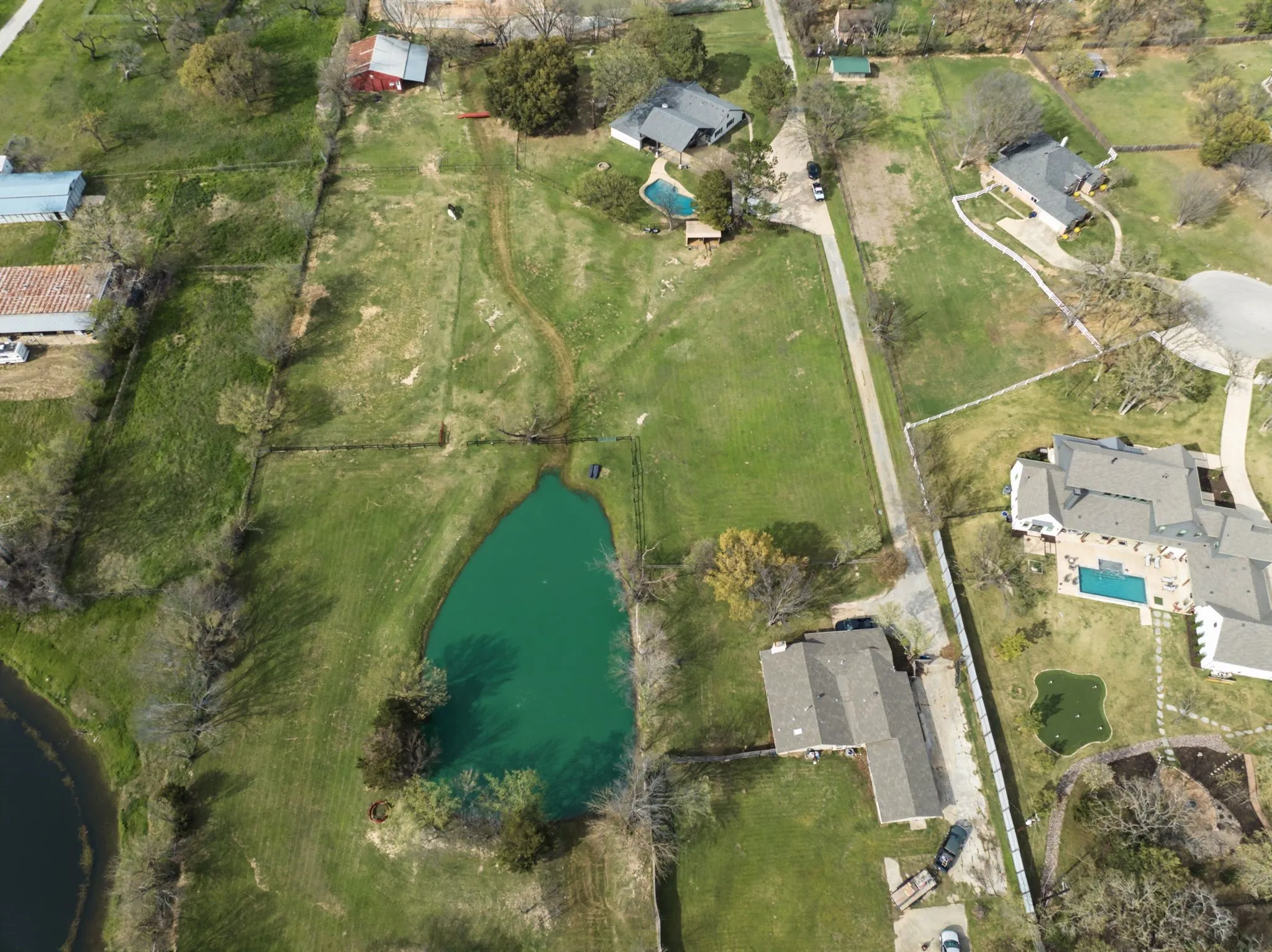 Expansive green spaces with a private pond and mature trees