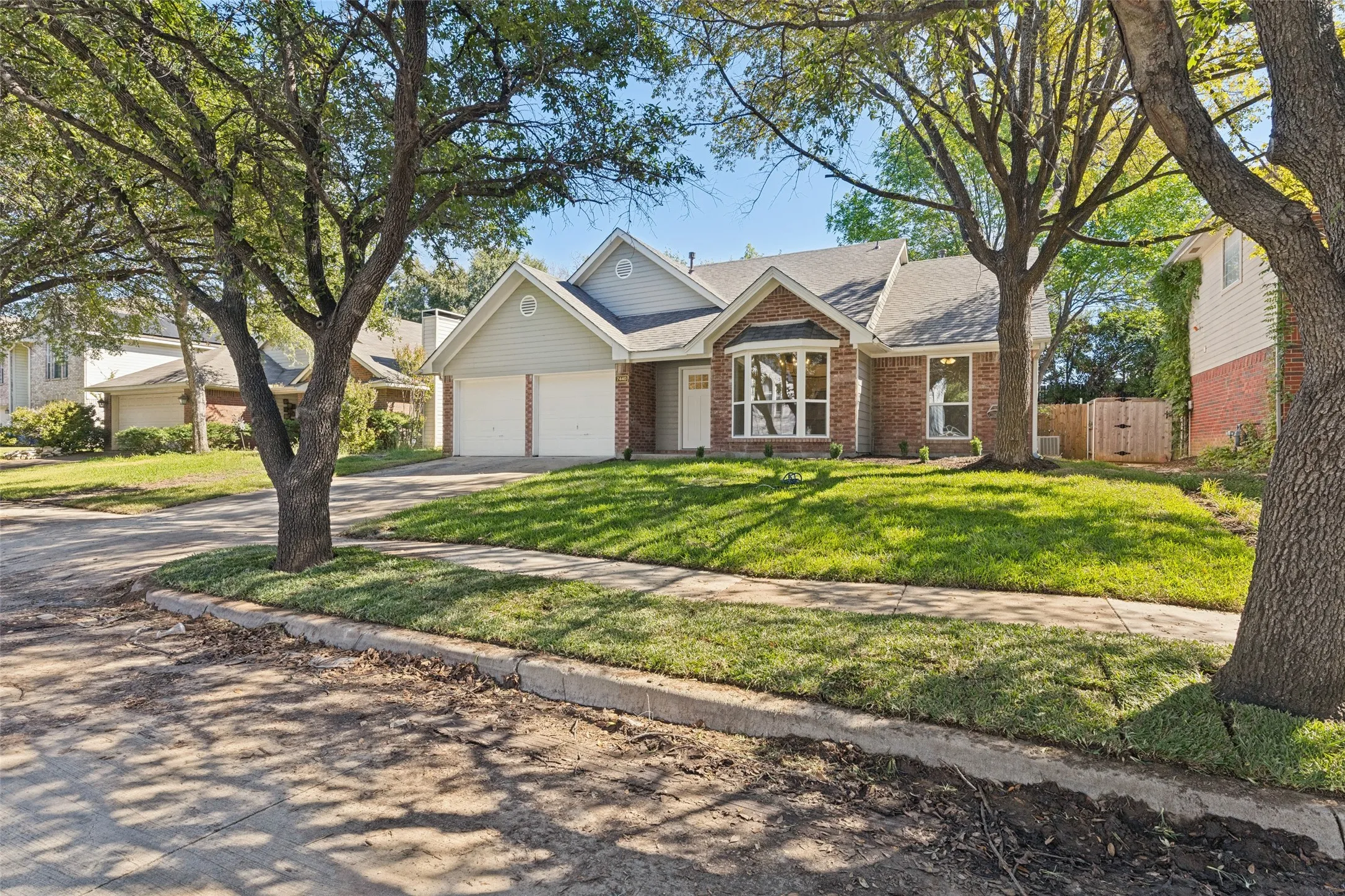 Red brick and siding exterior with a shingle roof