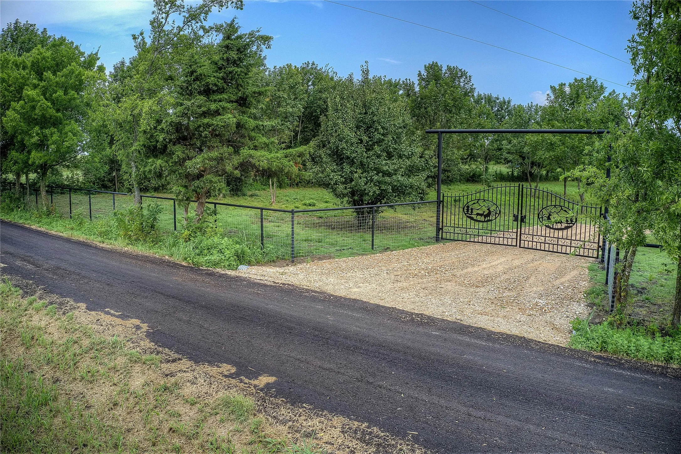View of road featuring a gate and a gated entry