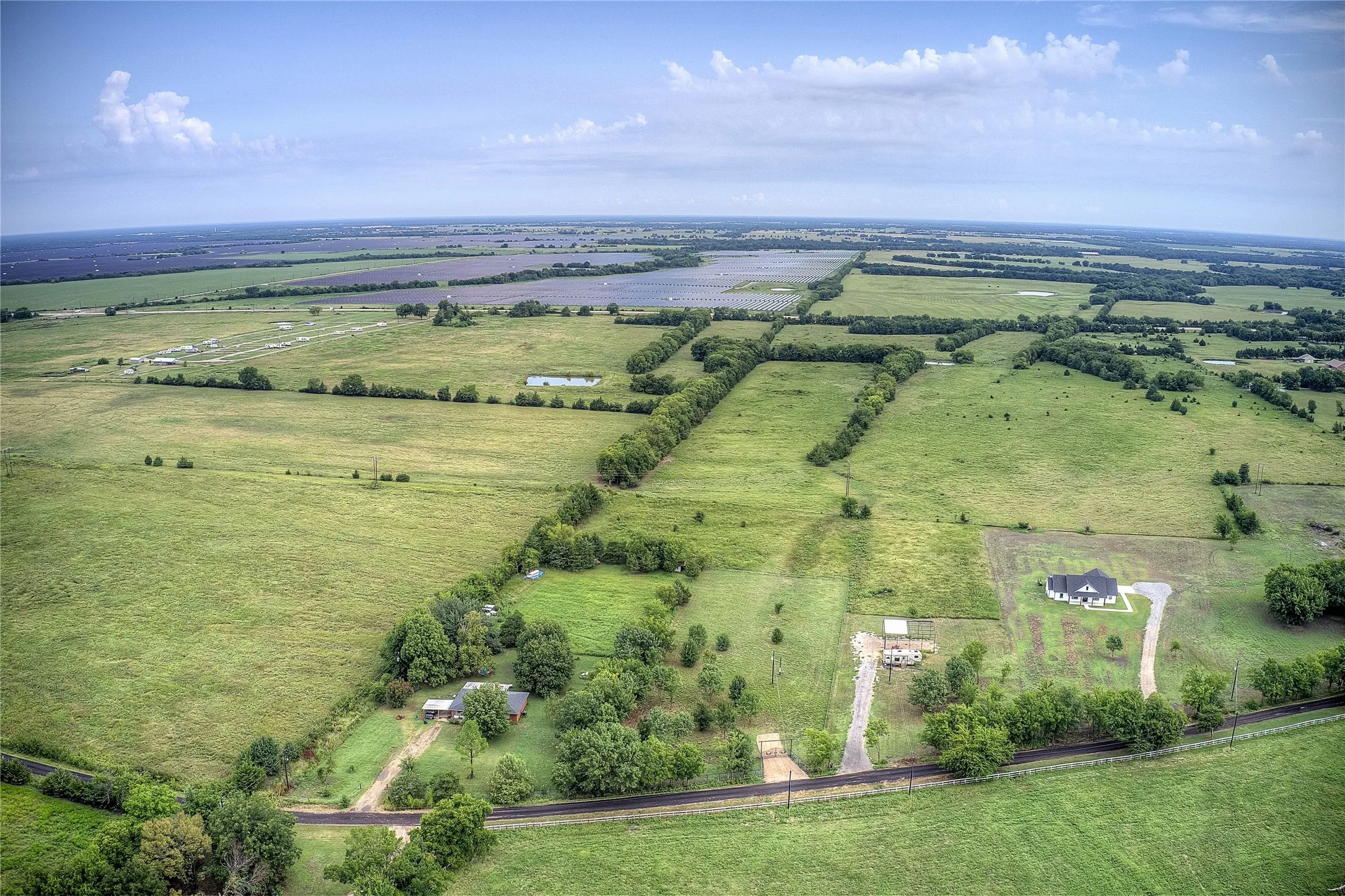 Aerial view of property and surrounding area with rural landscape and a pastoral area
