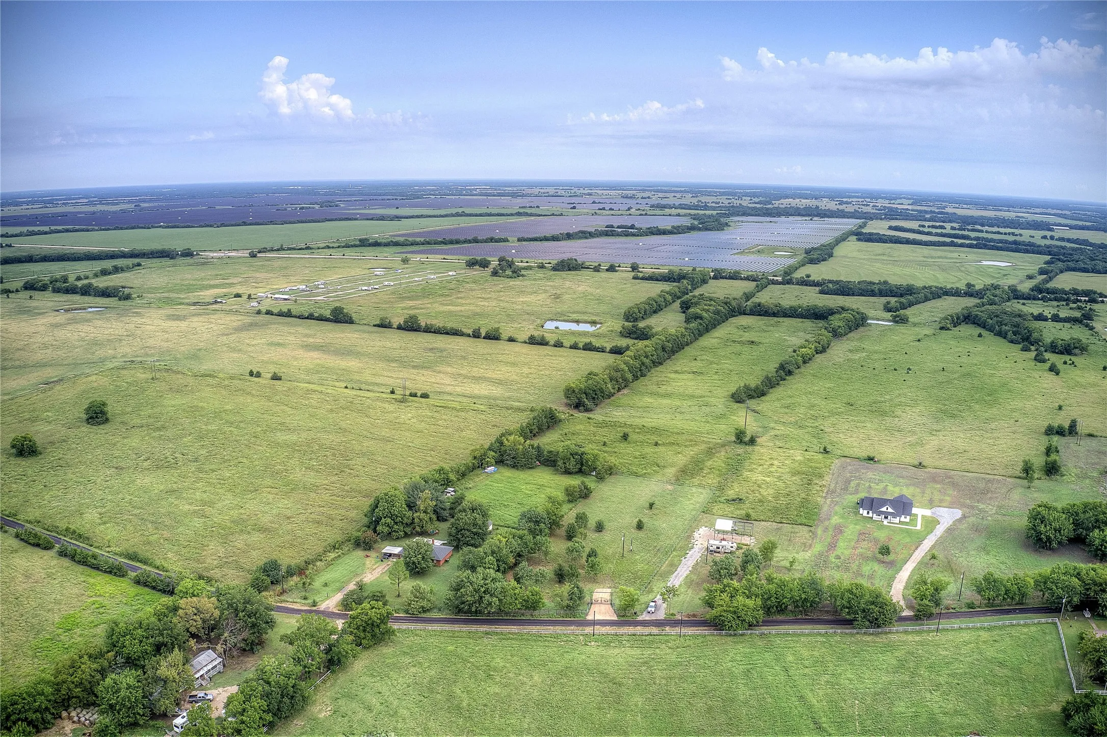 Aerial view of property and surrounding area featuring rural landscape