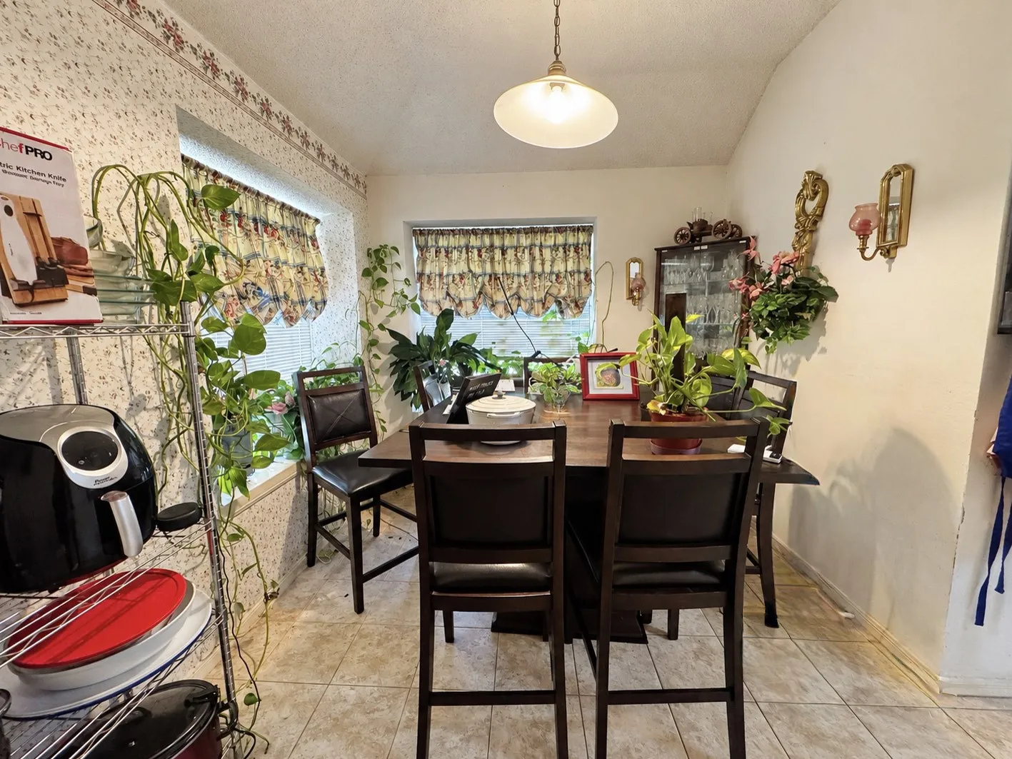 Tile flooring, vaulted ceiling, and recessed windows with valances