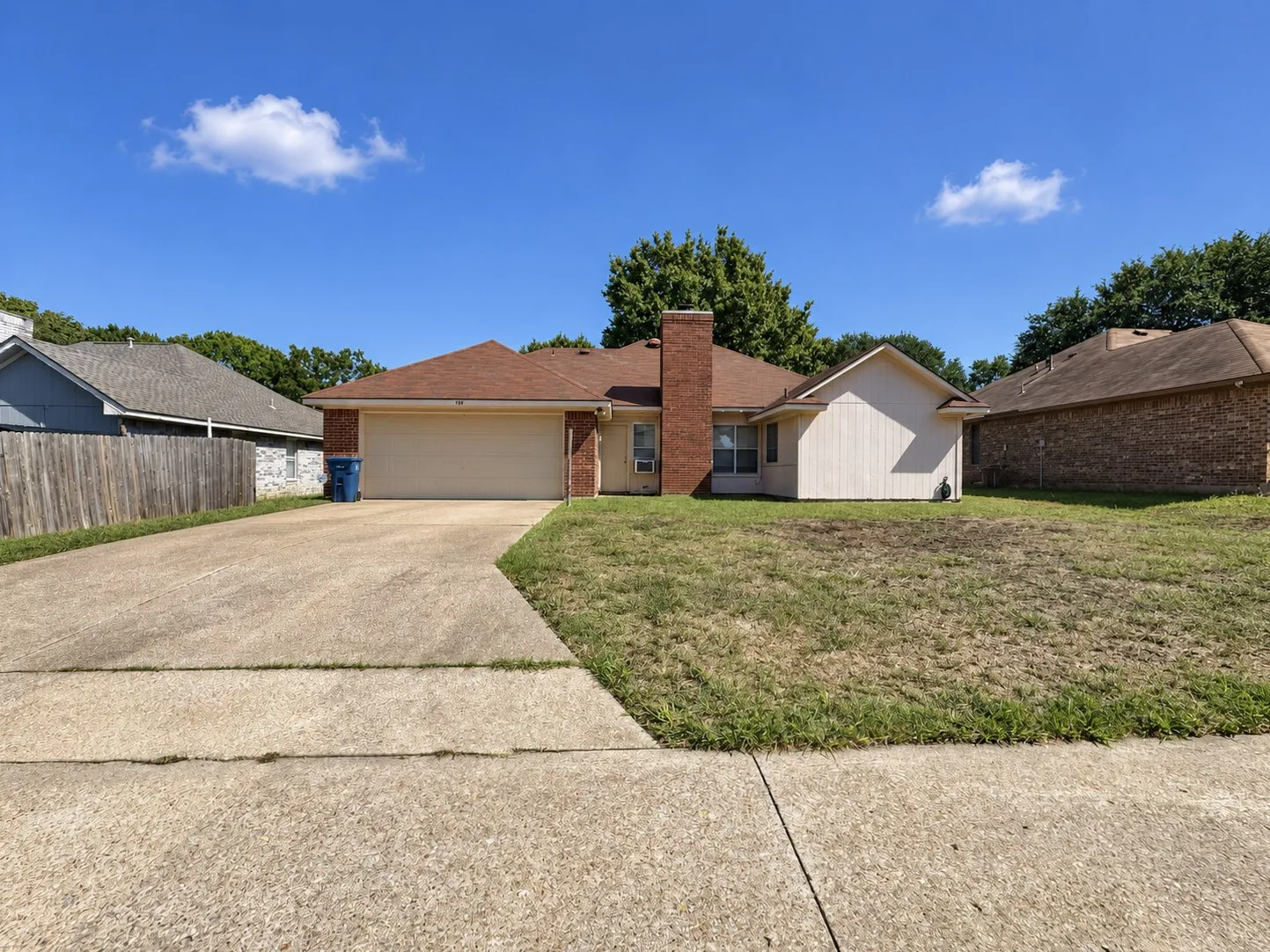 Single-story residence featuring a brick and siding exterior, an attached two-car garage, and a concrete driveway