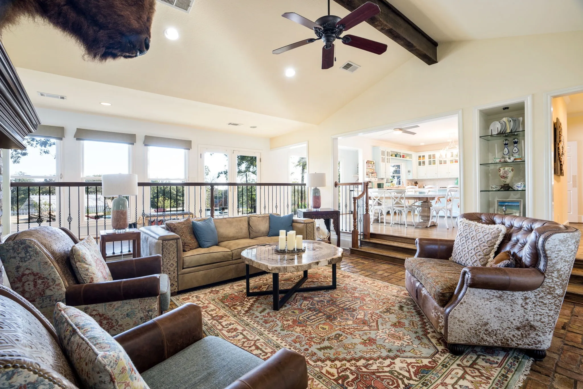 Vaulted ceiling with exposed wood beam, ceiling fan, and recessed lighting