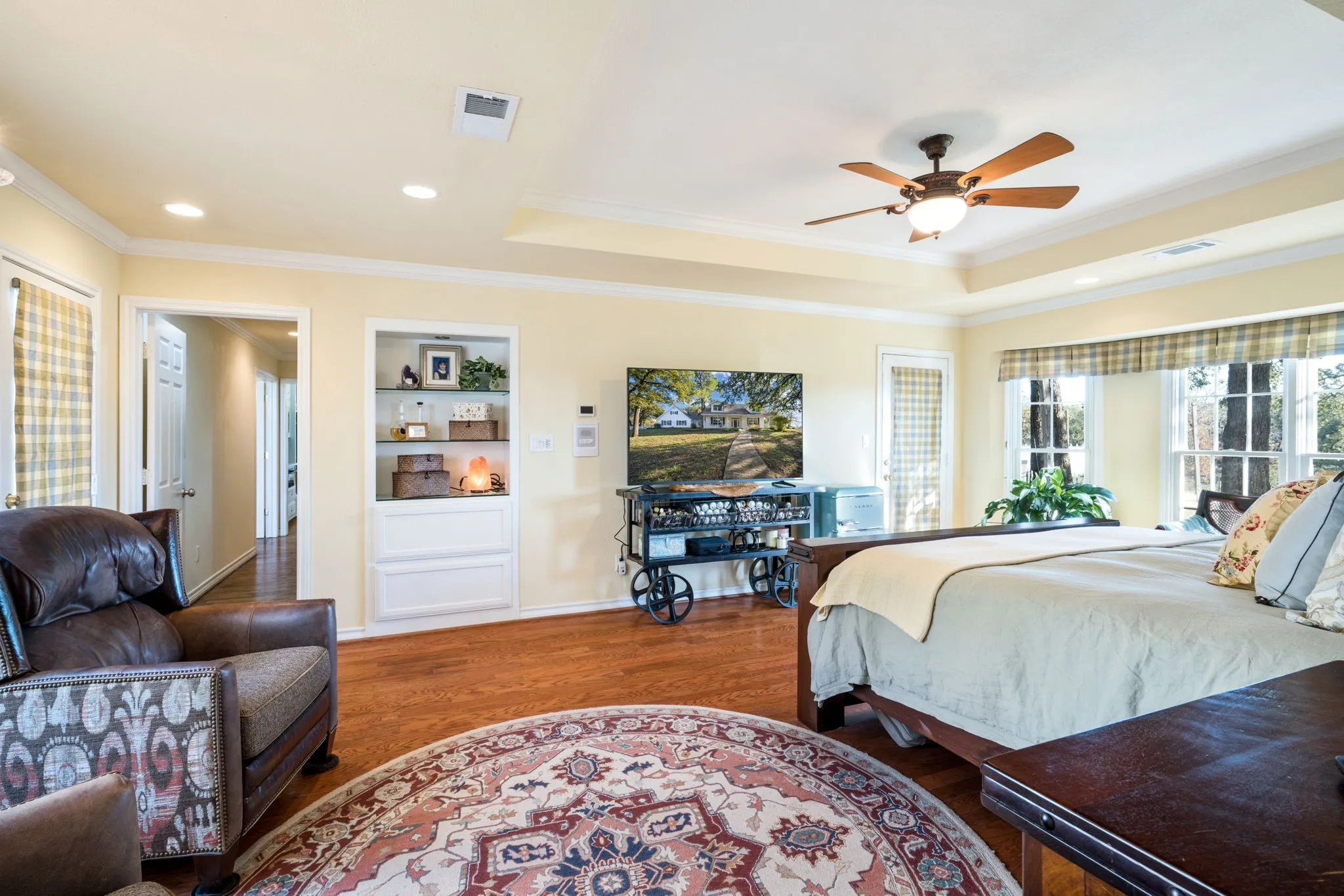 Recessed lighting, wood-finish flooring, built-in shelving, ceiling fan, and large windows