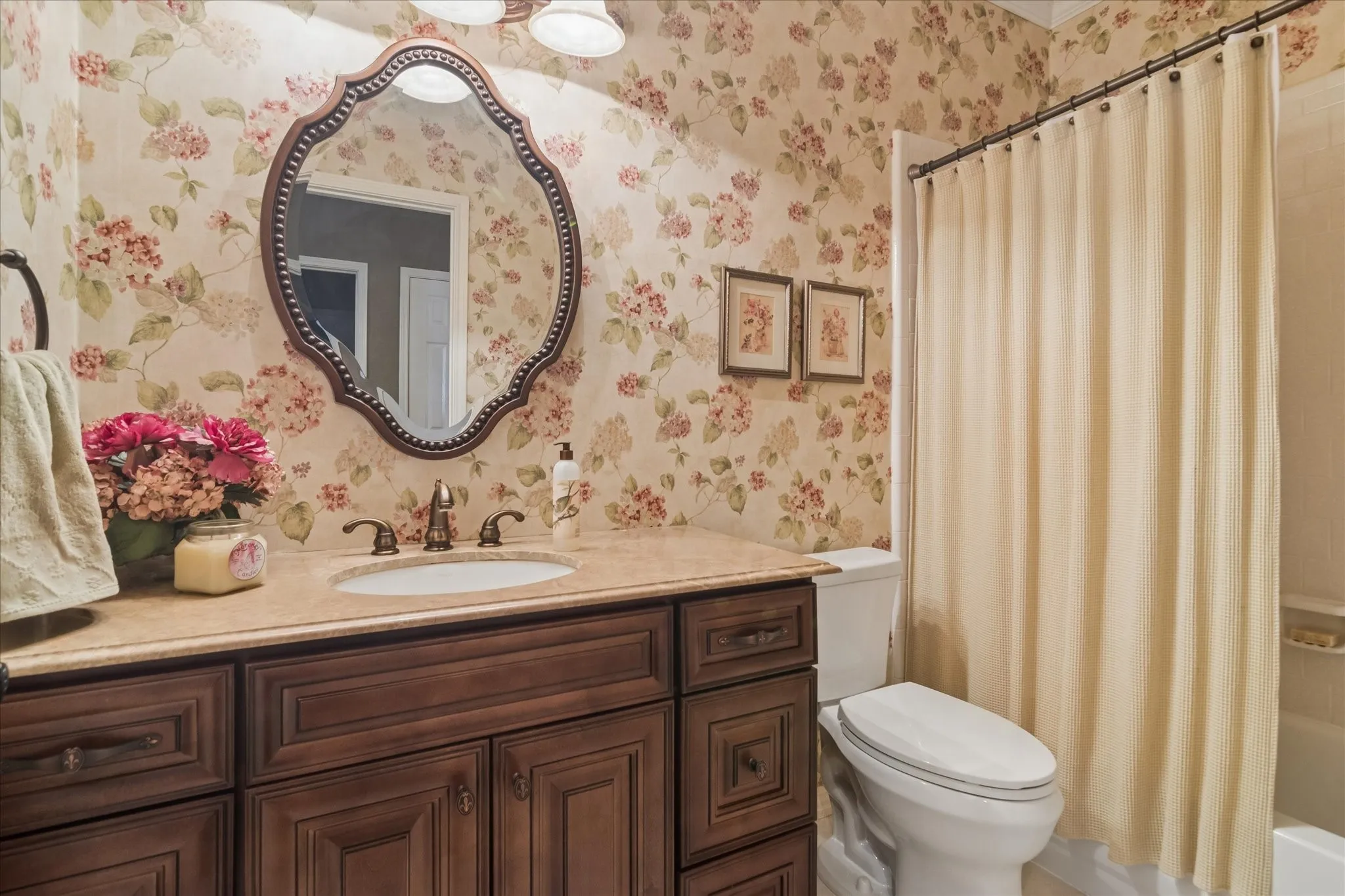 Vanity with decorative cabinetry, undermount sink, and bronze-finish faucet