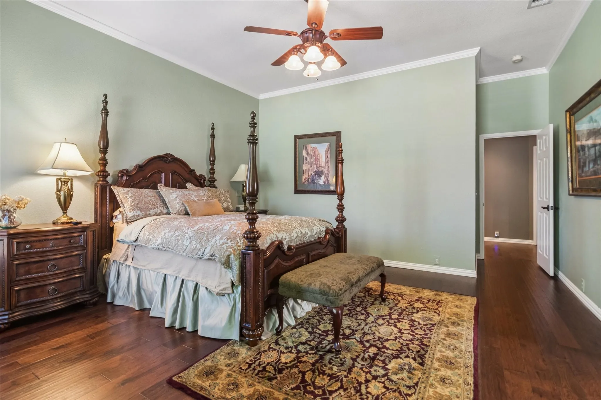Hardwood flooring, painted walls, crown molding, ceiling fan, and recessed doorway