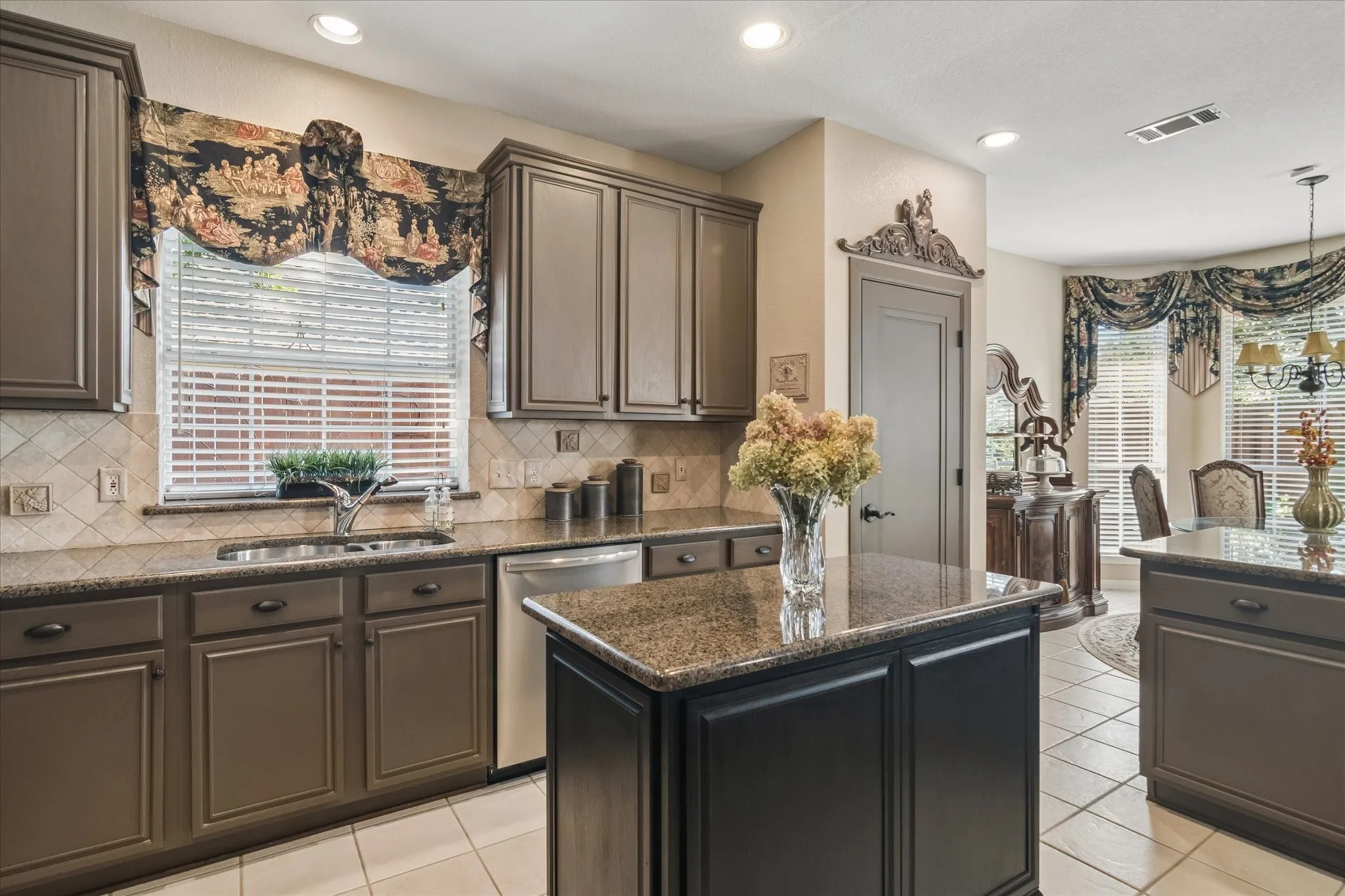 Kitchen featuring a center island, recessed lighting, tile flooring, and a stainless steel dishwasher