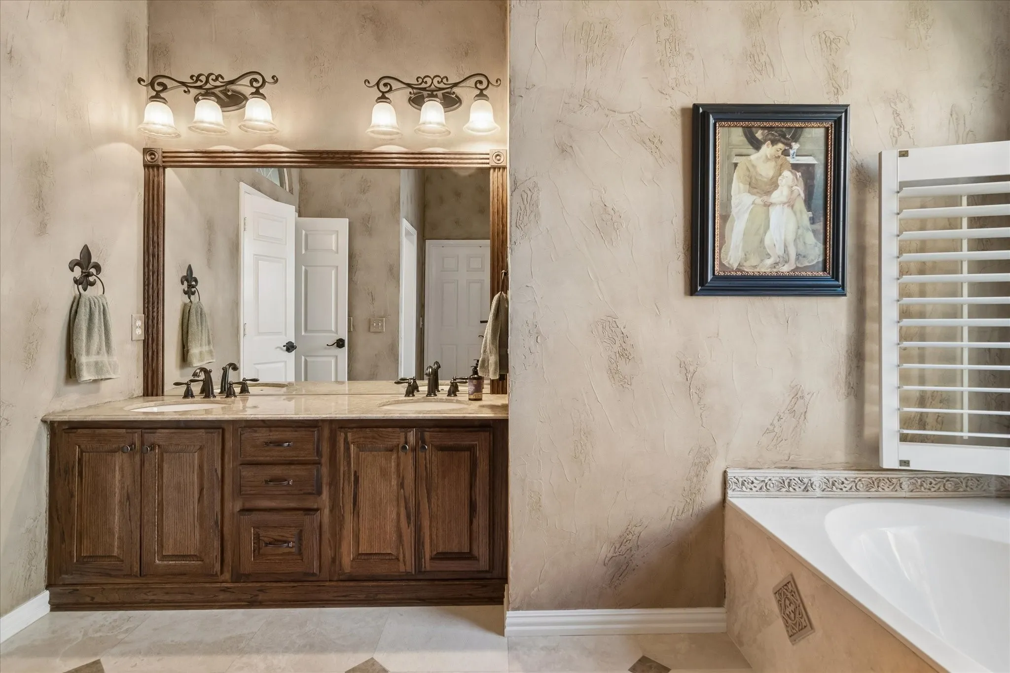 Dual vanity with wood-finish cabinetry and light-toned countertops