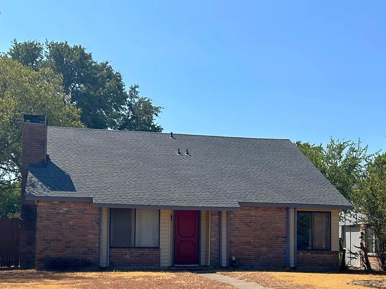 Brick facade with a contrasting red entry door