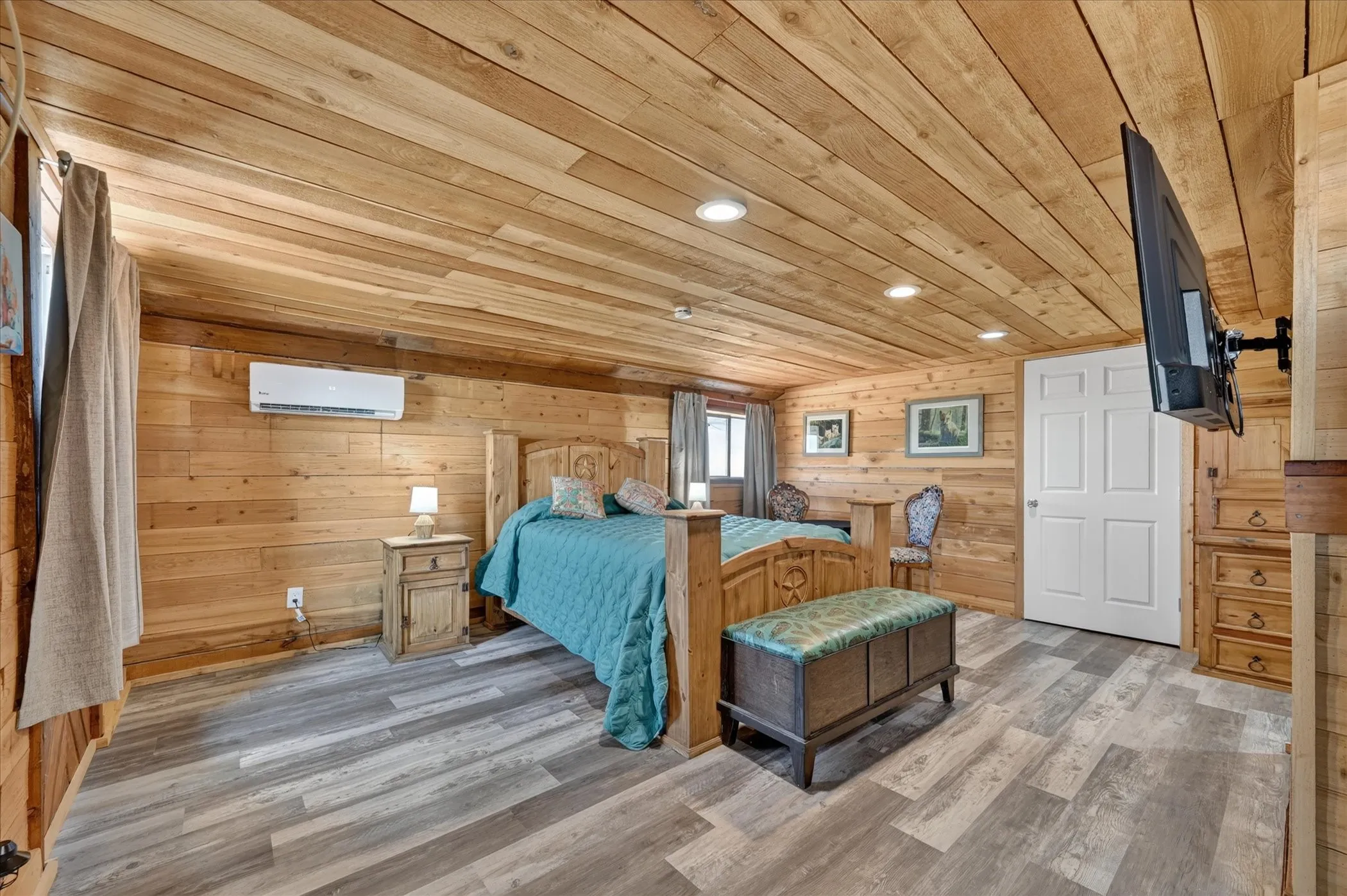 Wood-finish plank walls and ceiling, recessed lighting, wood-finish flooring, built-in cabinetry with drawers, and a white paneled door