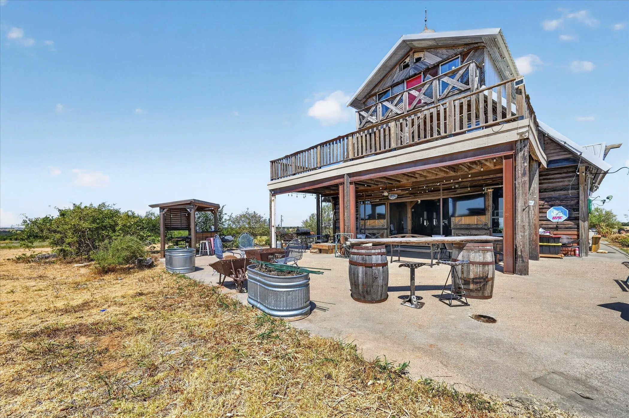 Multi-level wood-clad exterior with a concrete patio