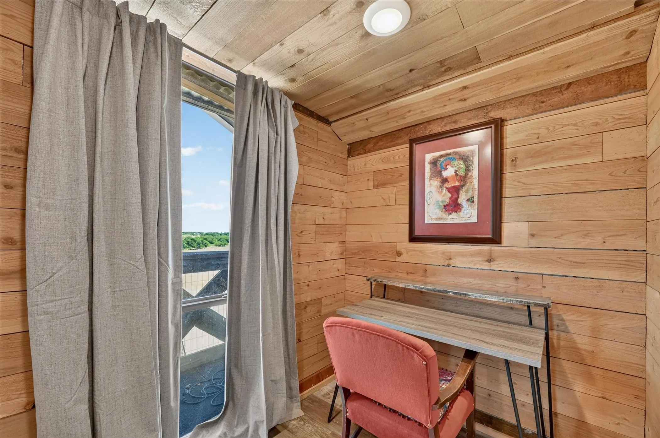 Wood paneling throughout, wood-finish flooring, and a recessed ceiling light
