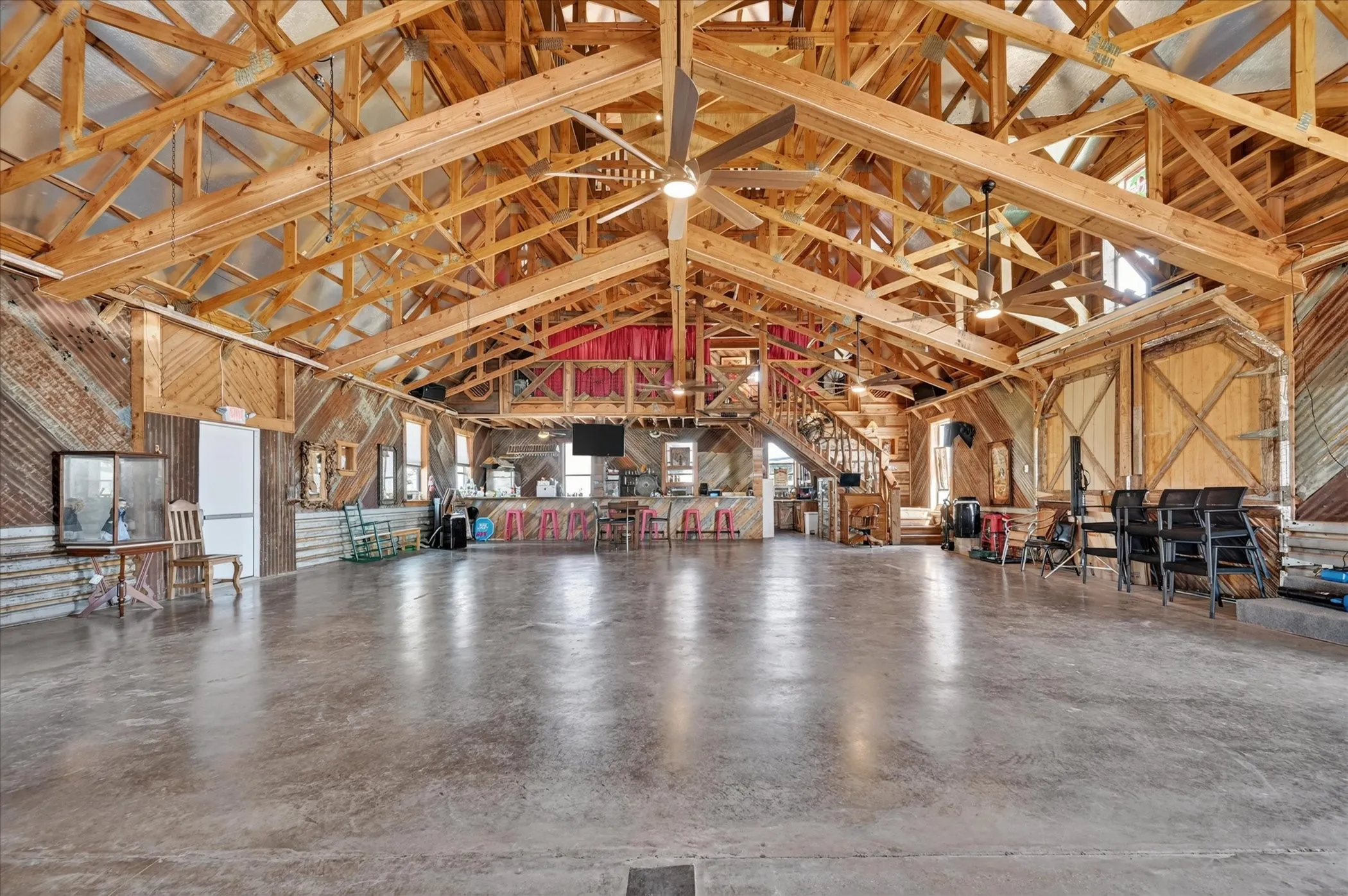 Exposed wooden beam ceiling with multiple ceiling fans