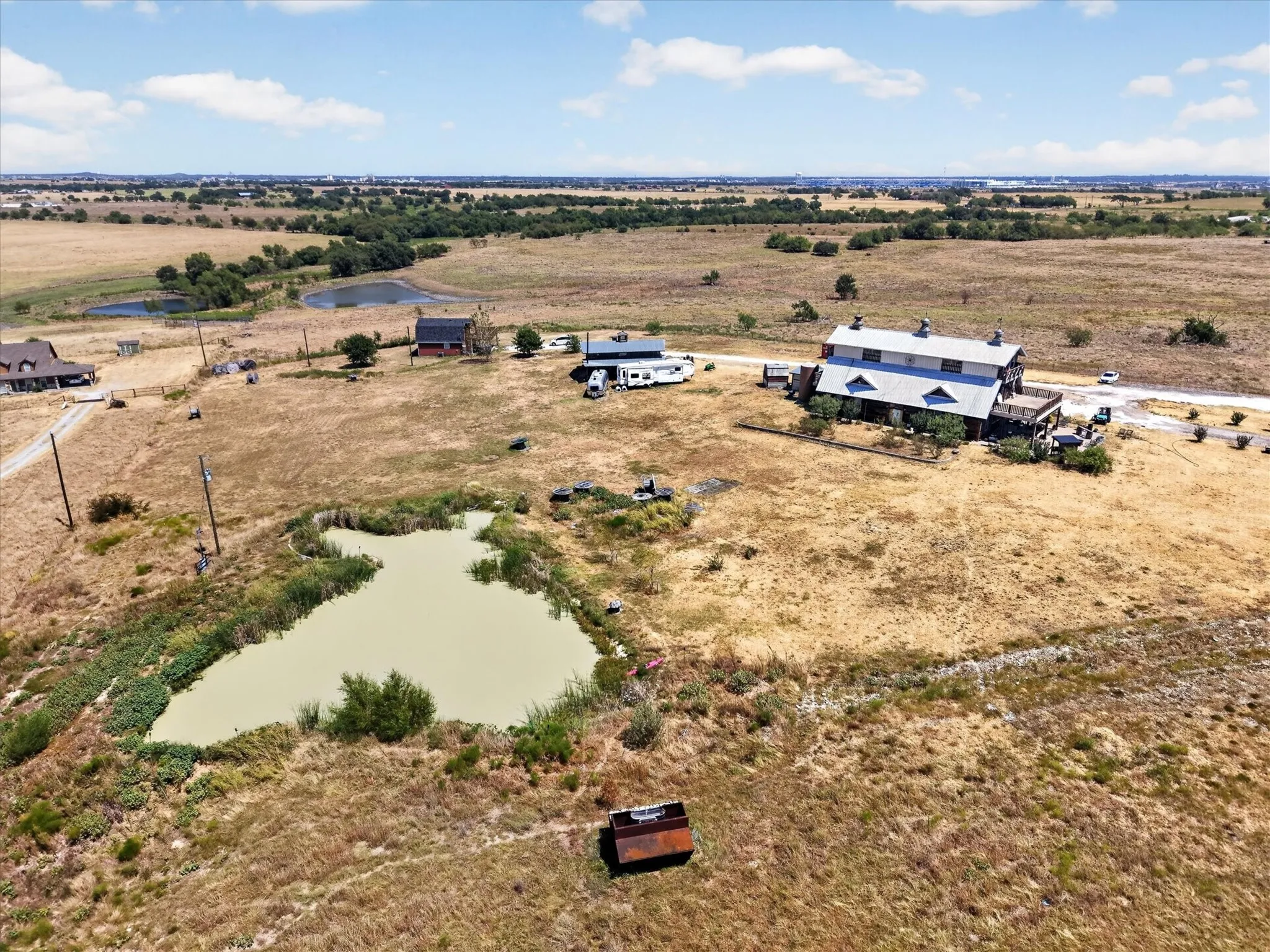 Expansive rural property featuring a large pond and an additional smaller pond