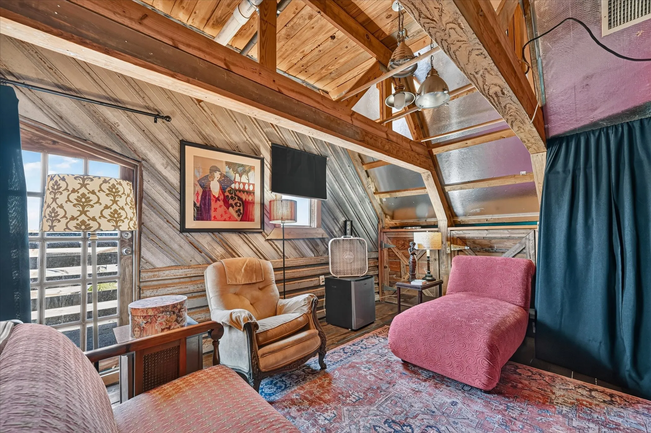 Vaulted wood-plank ceiling with exposed beams, wood-paneled walls, and multiple windows