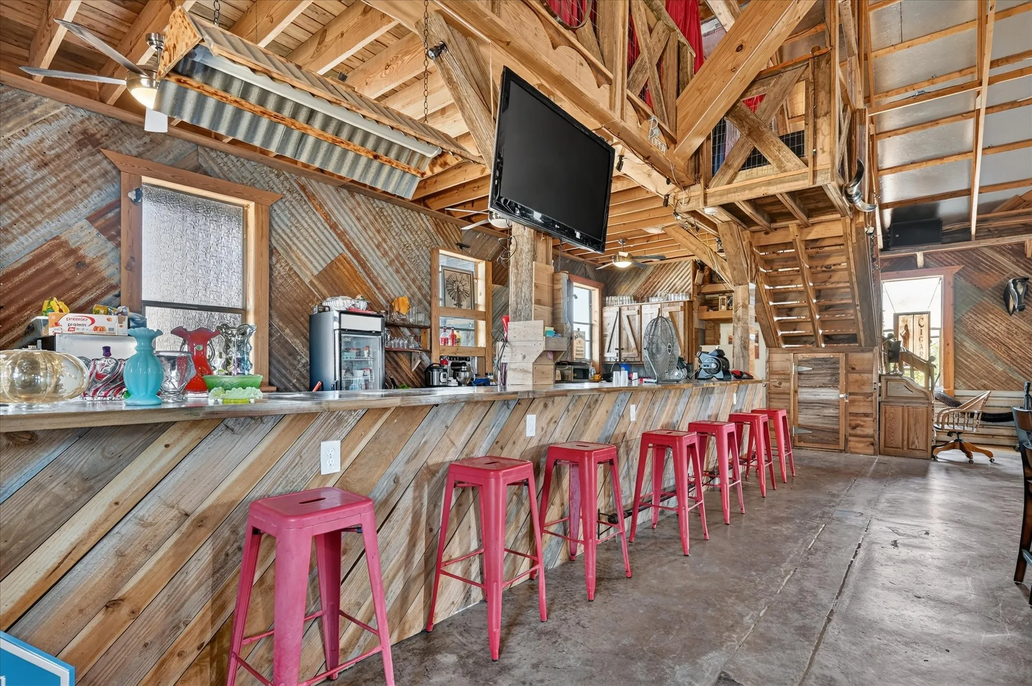 Reclaimed wood paneling and corrugated metal accents complement the substantial wooden beam construction