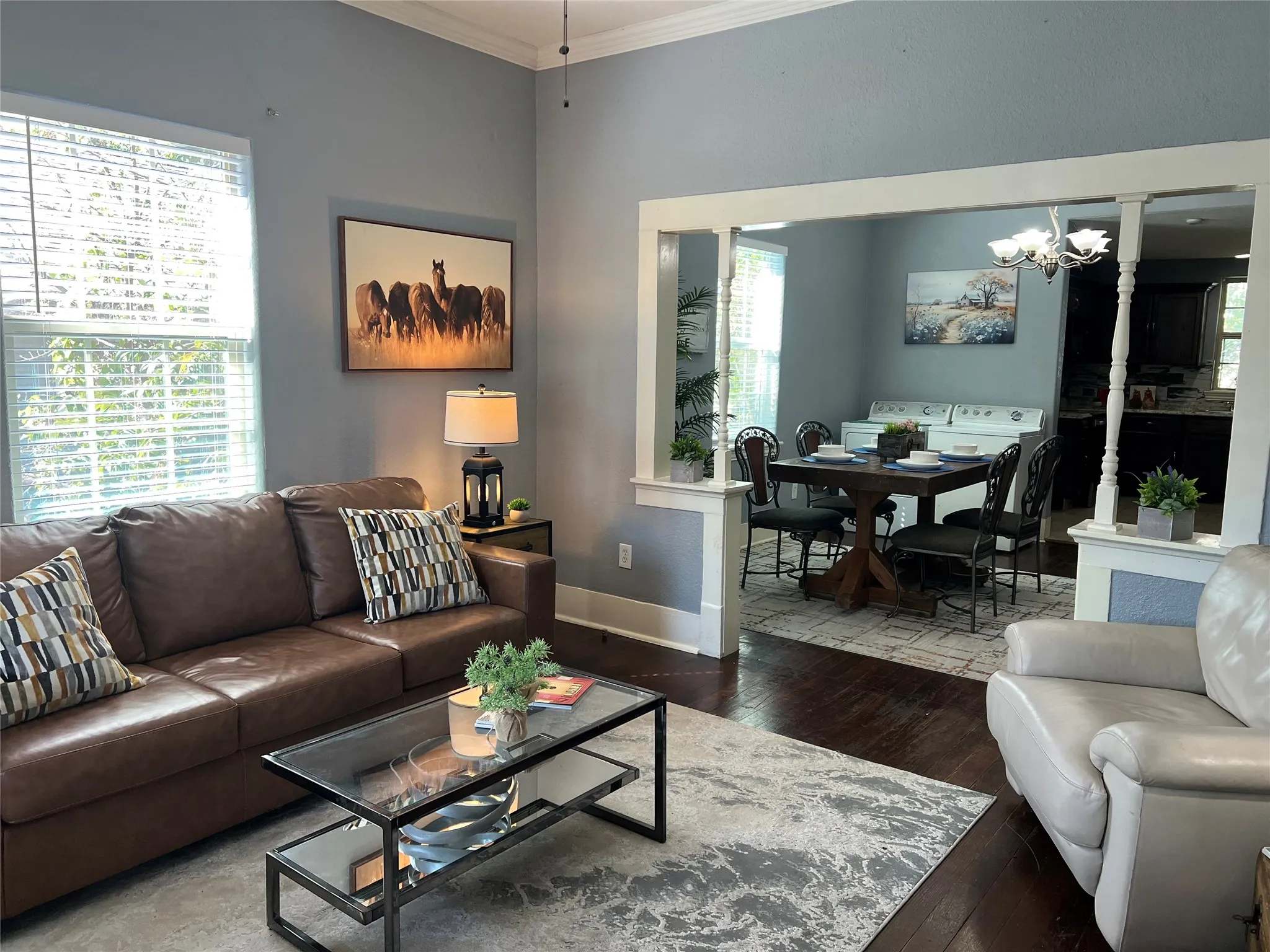 Hardwood flooring, crown molding, and a high ceiling
