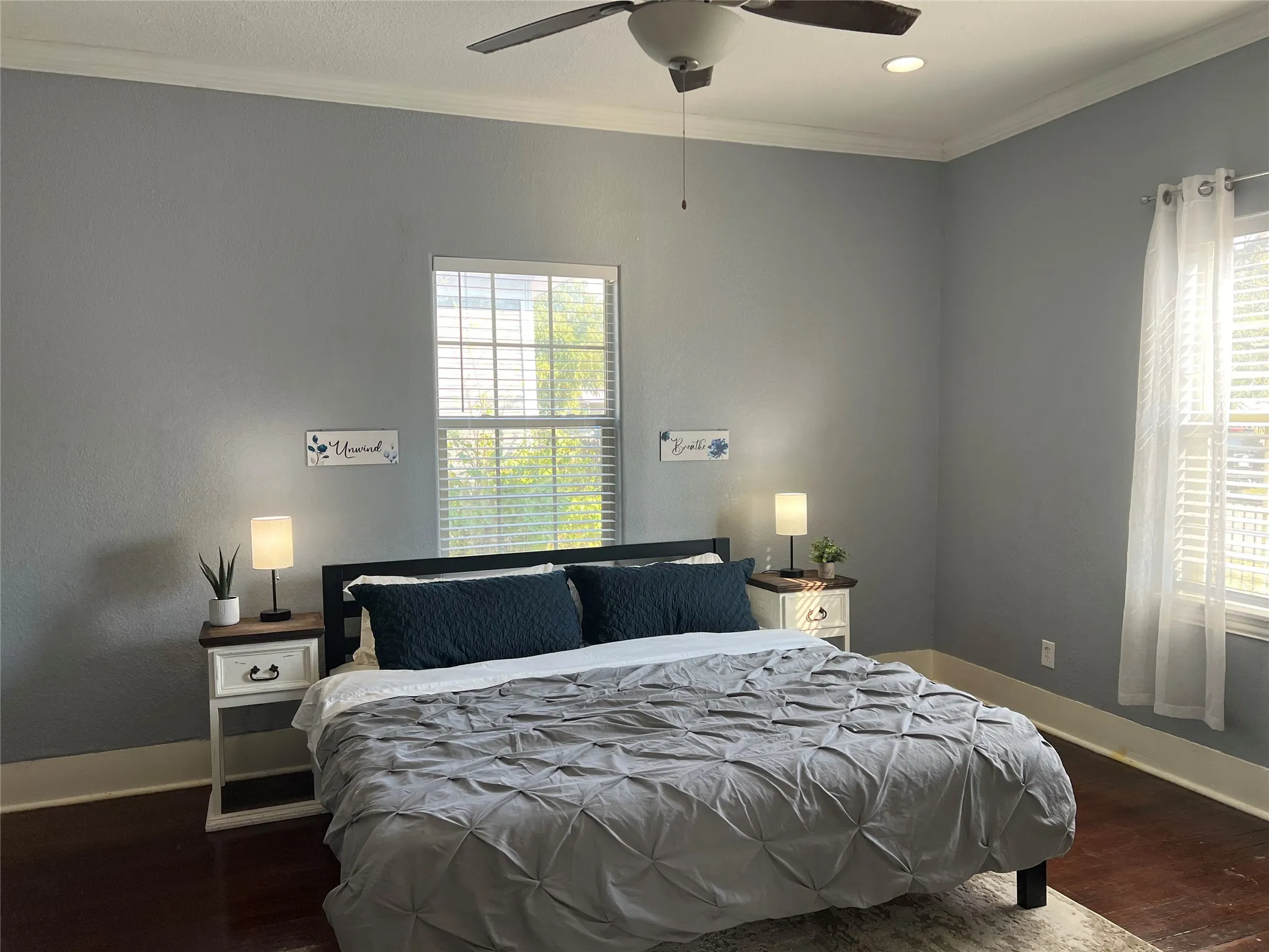 Wood-finish flooring, crown molding, and recessed lighting