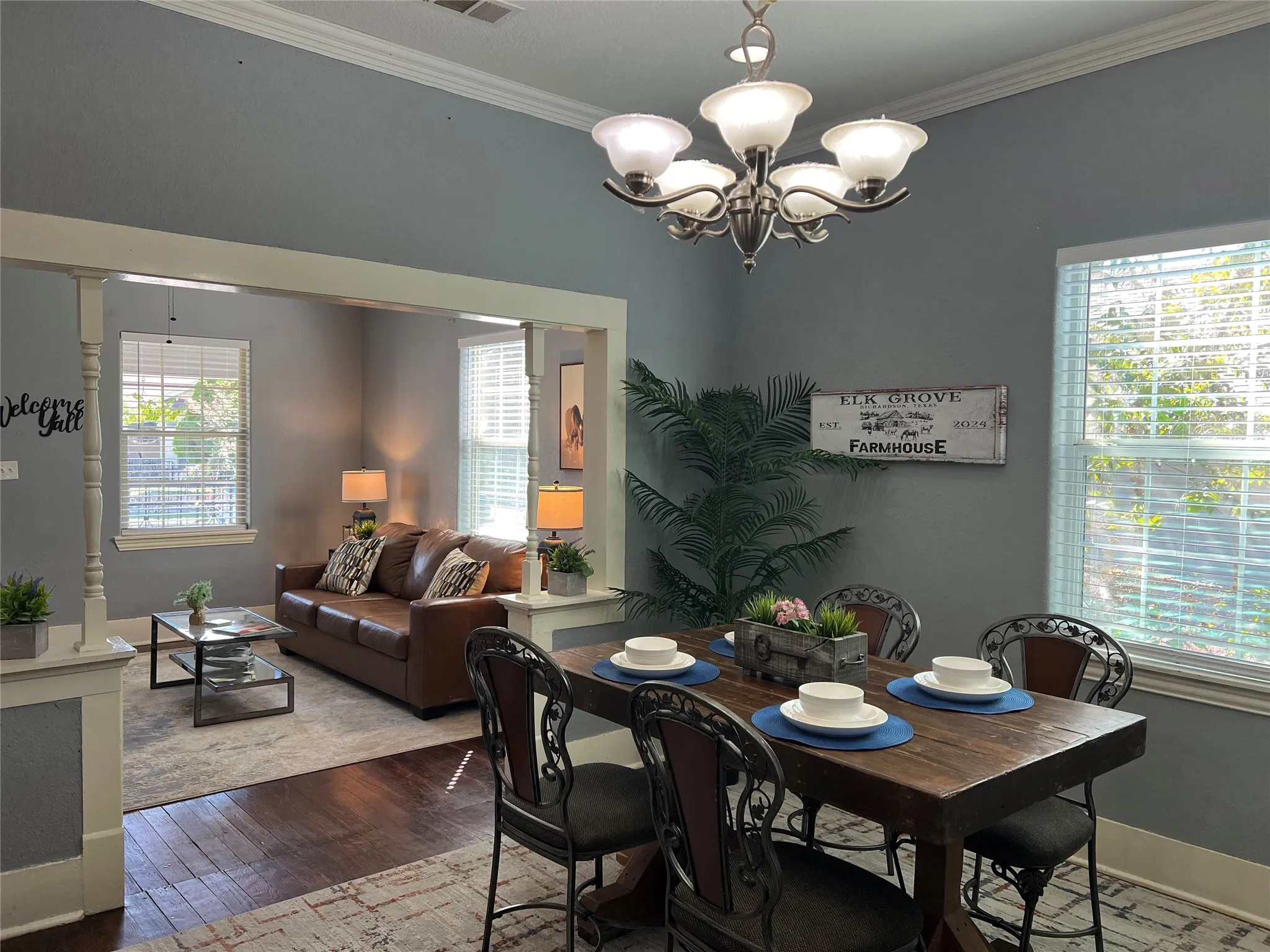 Open-concept living and dining areas featuring crown molding, recessed lighting, and wood-finish​​‌​​​​‌​​‌‌​‌‌​​​‌‌​‌​‌​‌​​​‌​​ flooring