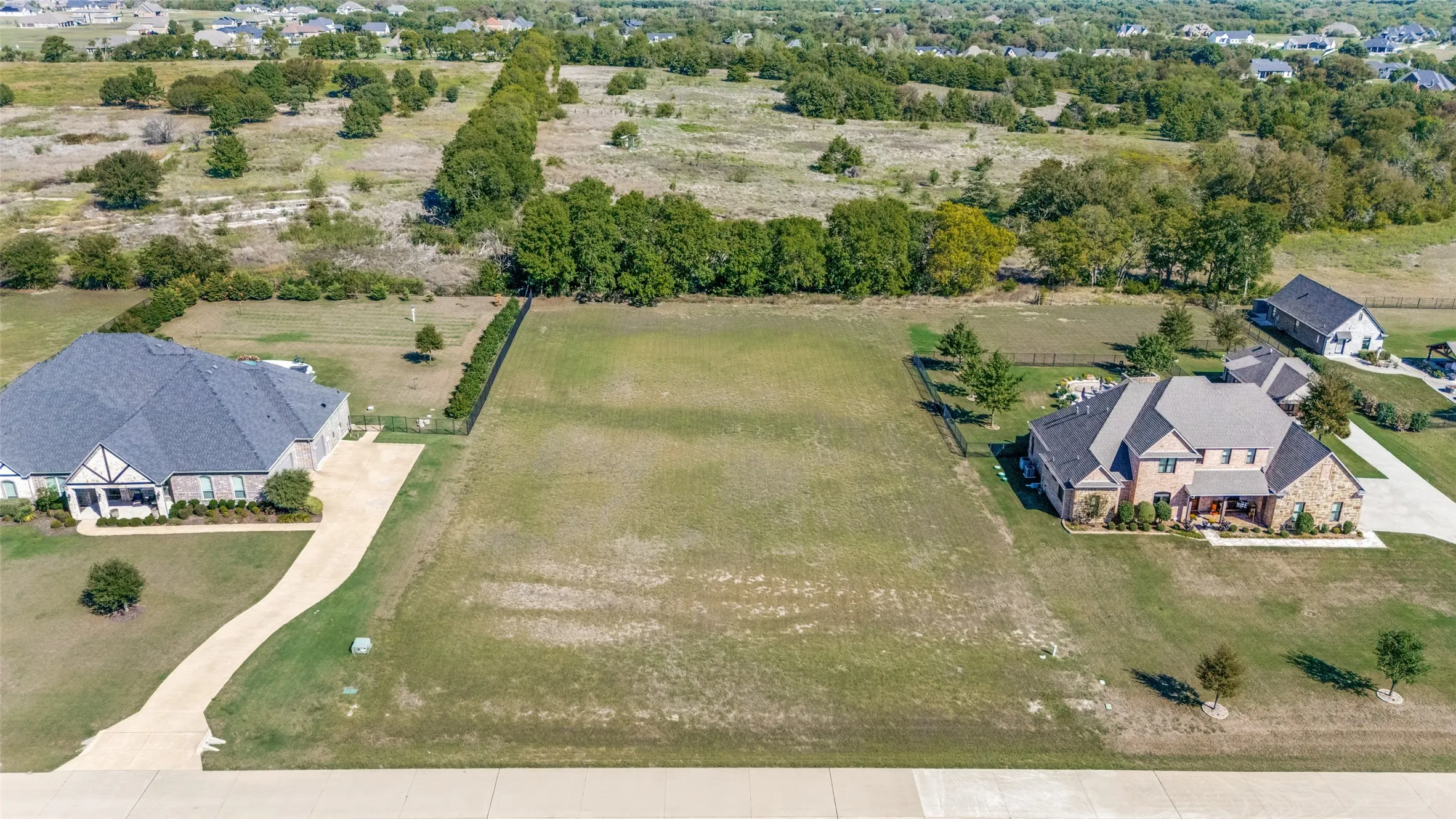 Expansive level lot with mature perimeter trees and partially fenced boundaries
