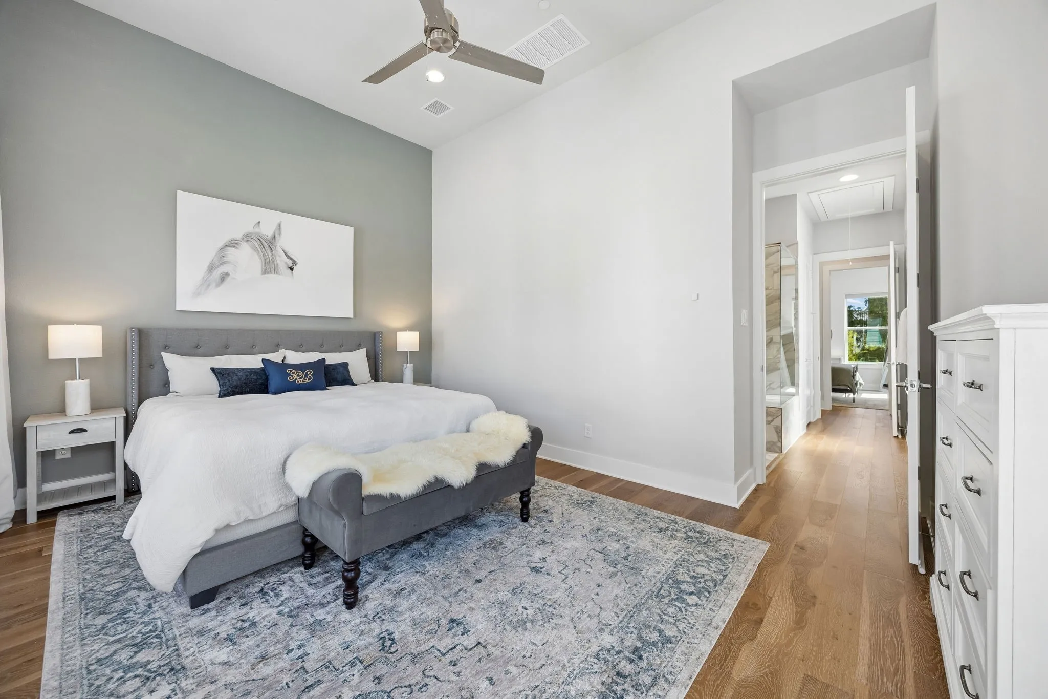 A long hallway with closet and ensuite provides added privacy between the Primary and Secondary Bedroom Suites.