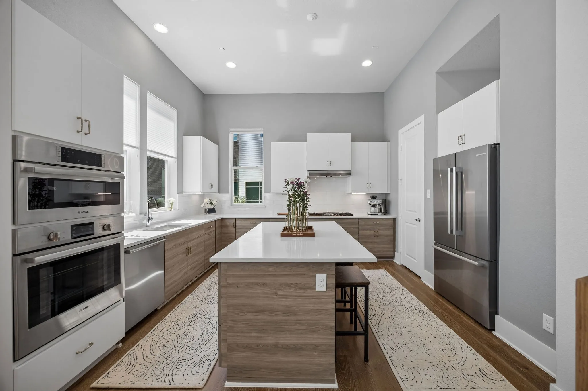 The kitchen features an abundance of storage, dedicated pantry, high ceilings filled with natural light