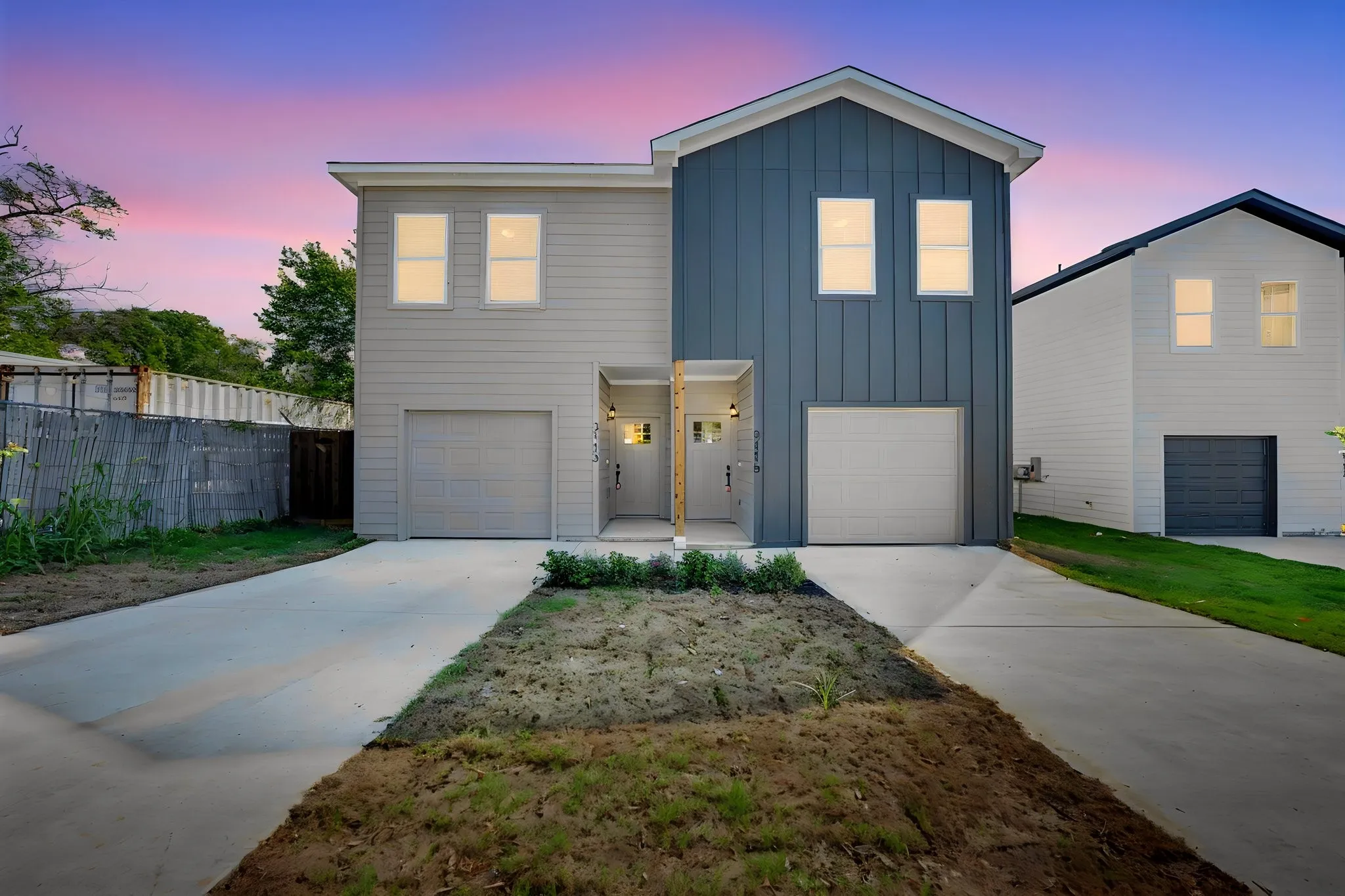 Modern two-story townhome featuring a mix of horizontal siding and vertical board and batten