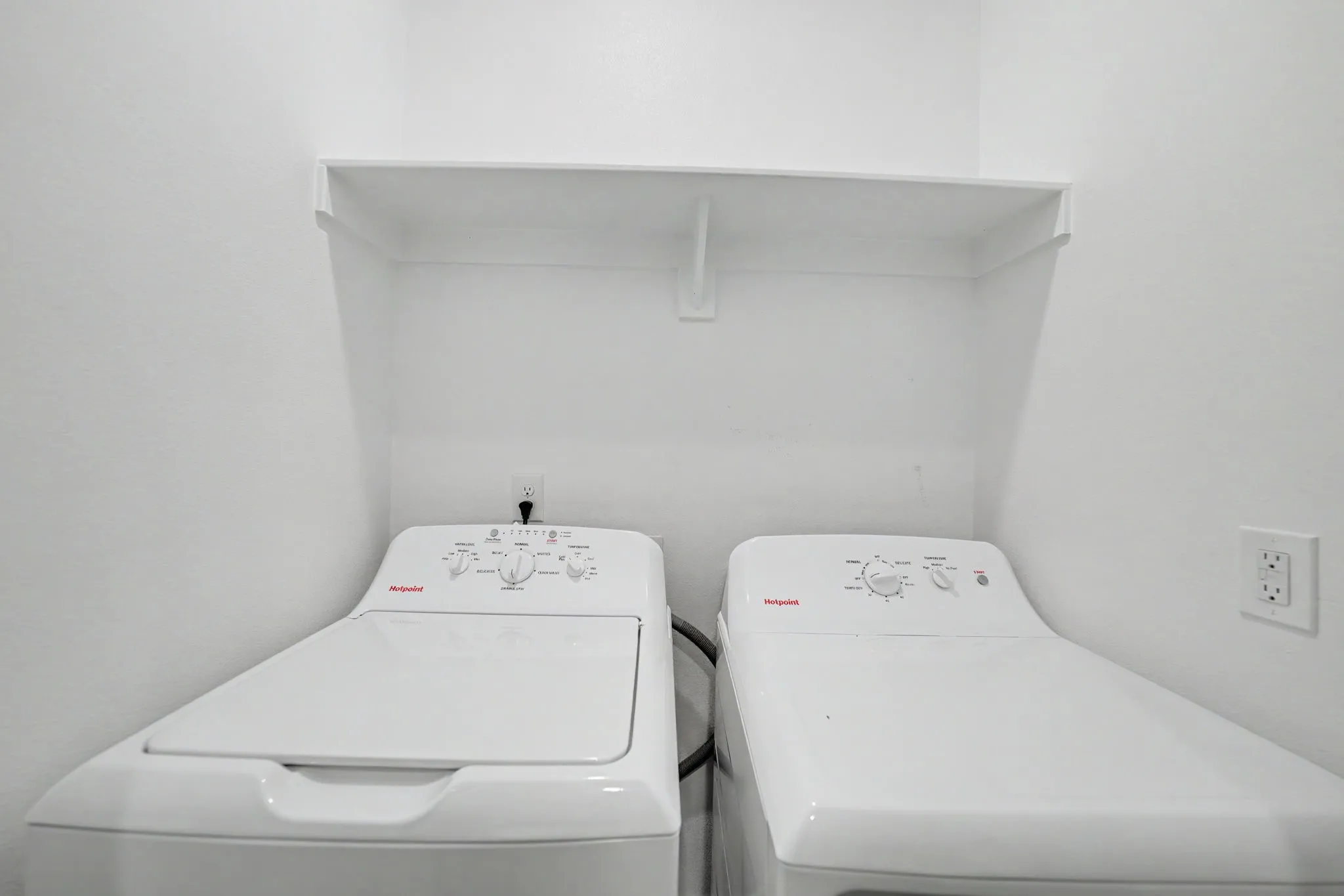 Laundry area with a built-in white shelf