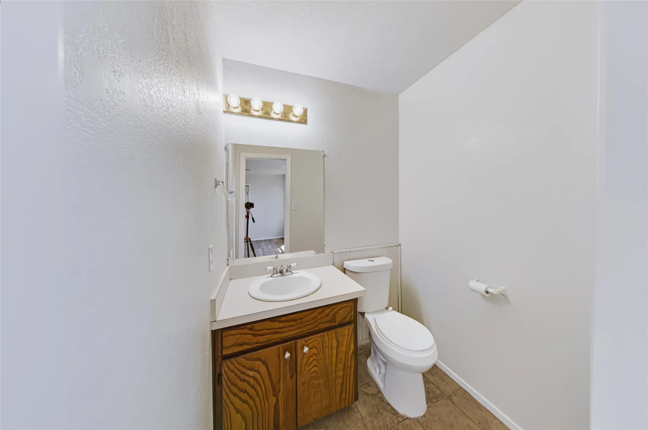 Vanity with wood-finish cabinetry and integrated sink