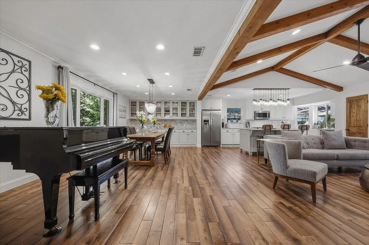 Beautiful wood look floors, raised ceiling, open and spacious.