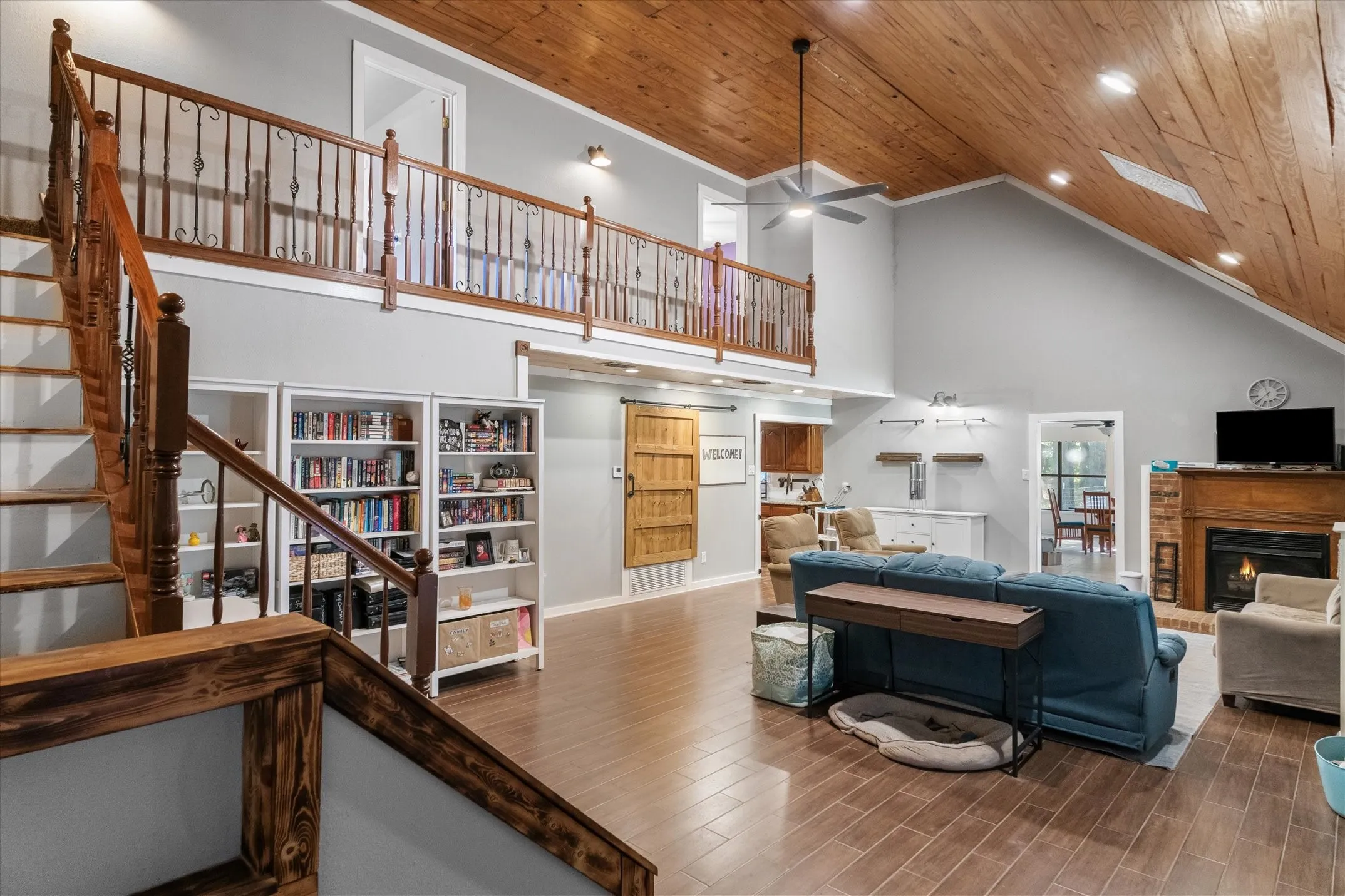 Large open & airy living room with ventless gas fireplace.