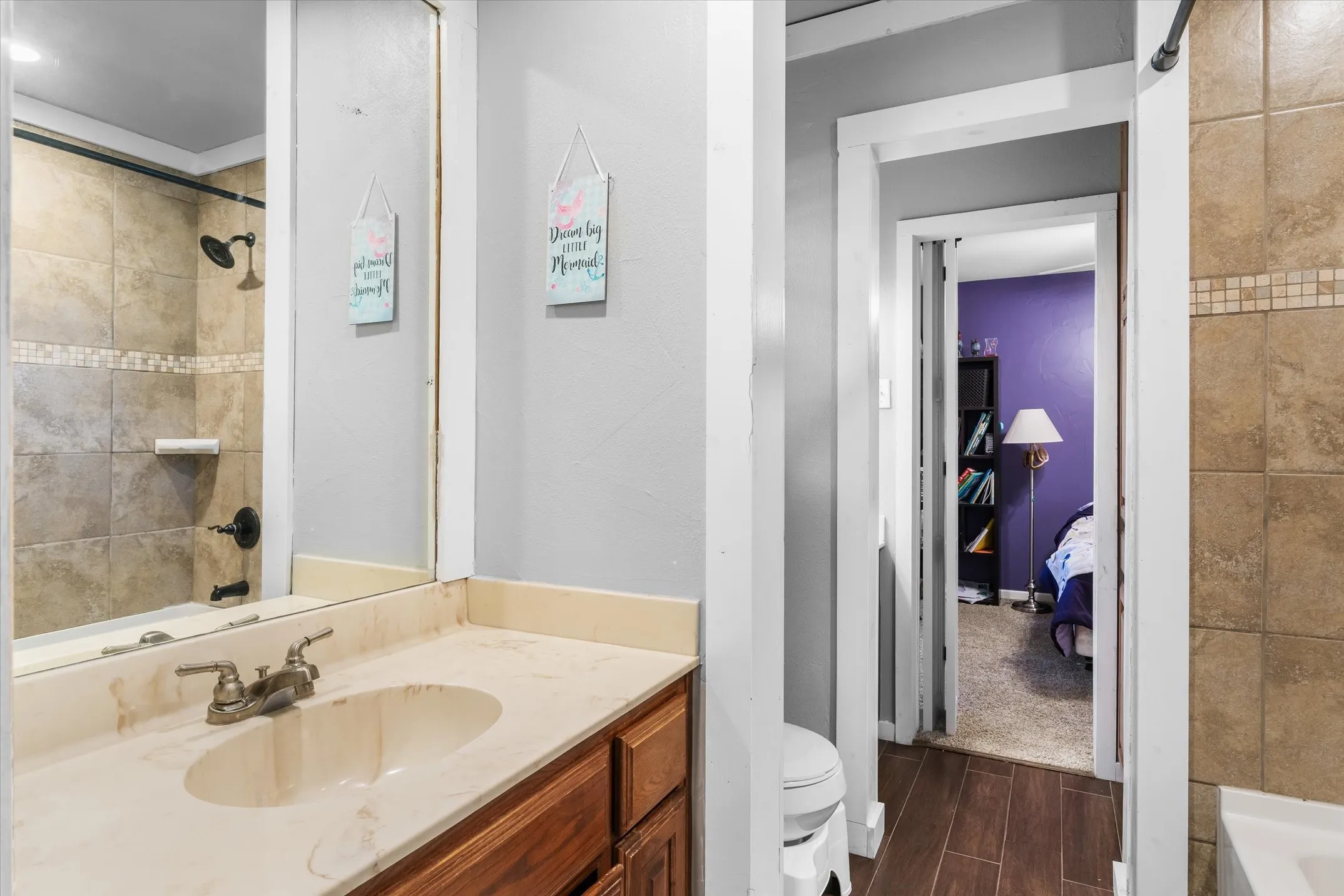 Jack-n-Jill bath features separate vanities.