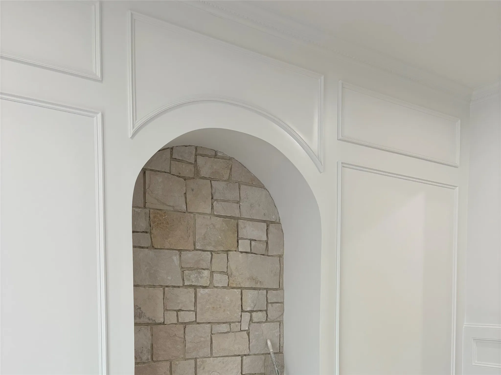 Archway with stone-finish interior and detailed wall paneling