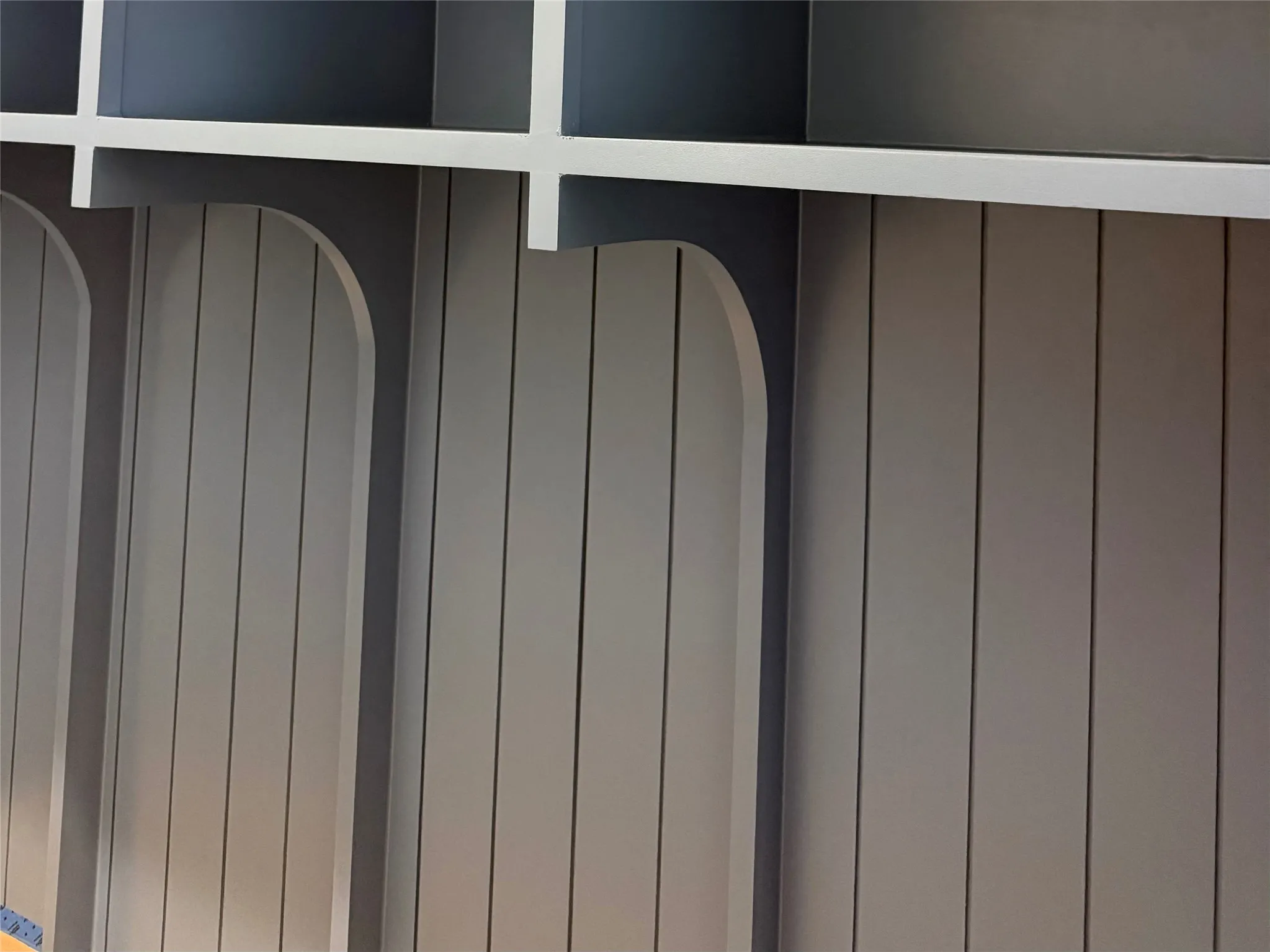 Built-in shelving with cubbies and vertical paneling